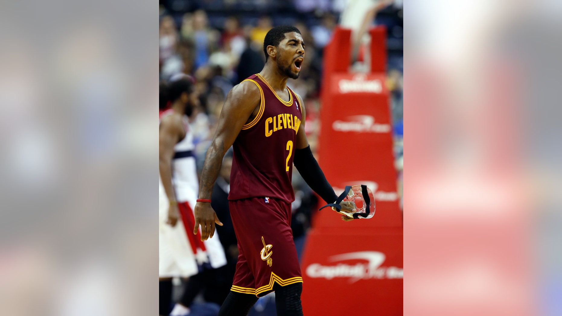 Cleveland Cavaliers guard Kyrie Irving (2) celebrates his shot during a timeout in overtime of an NBA basketball game against the Washington Wizards, Saturday, Nov. 16, 2013, in Washington. Irving had 41 points and the Cavaliers won 103-96. (AP Photo/Alex Brandon)