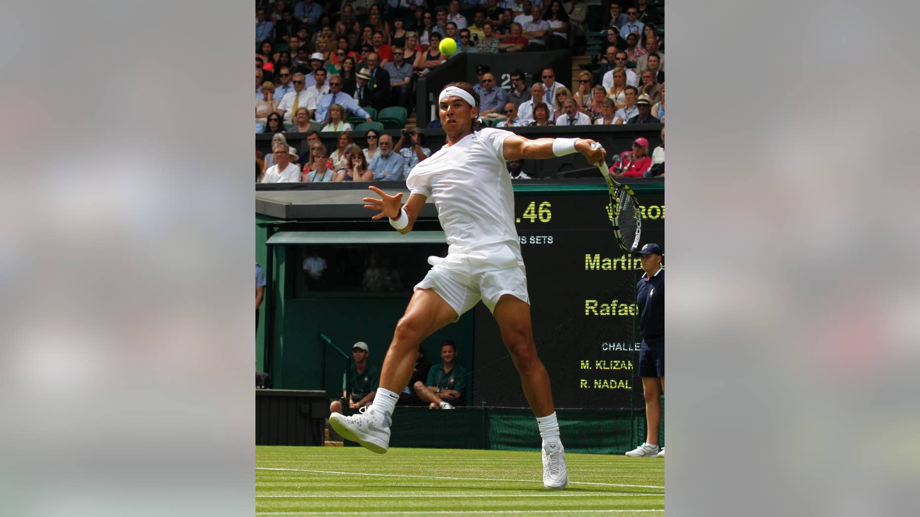 Rafael Nadal of Spain plays a return to Martin Klizan of Slovakia match at the All England Lawn Tennis Championships in Wimbledon, London, Tuesday, June 24, 2014. (AP Photo/Sang Tan)
