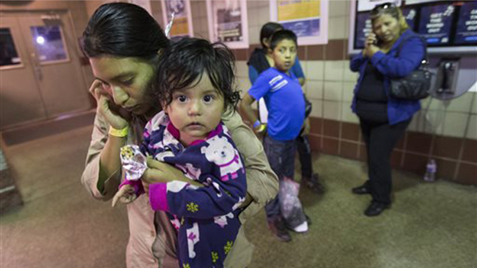 Judy Martinez tries to reach family after being released by ICE at a Greyhound Bus station in Phoenix, May 28, 2014.