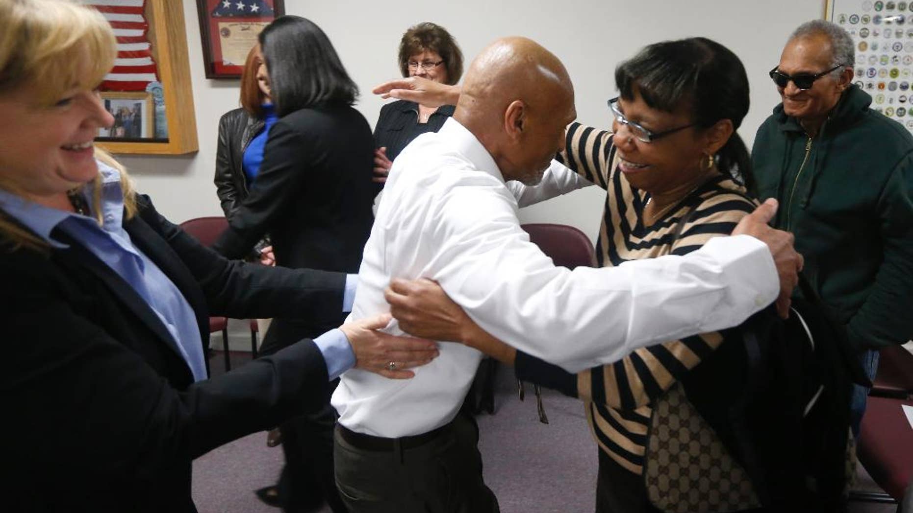 Joseph Sledge hugs his sister Barbara Kinlaw after a special session of superior court in Whiteville, N.C. on Friday, Jan. 23, 2015. Sledge, 70, was freed from prison Friday, after a panel of judges found that he was wrongly convicted in the stabbing deaths of a mother and daughter nearly four decades ago. Christine Mumma, director of the North Carolina Center on Actual Innocence, is to the left. (AP Photo/The News & Observer, Ethan Hyman)