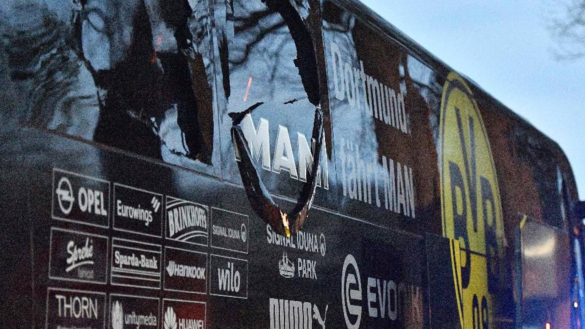 FILE - In this April 11, 2017 file photo a window of Dortmund's team bus is damaged after an explosion before the Champions League quarterfinal soccer match between Borussia Dortmund and AS Monaco in Dortmund, Germany. German prosecutors say they’re staging a reconstruction of last week’s attack on Borussia Dortmund’s team bus as they look for clues on the perpetrators. (AP Photo/Martin Meissner,file)