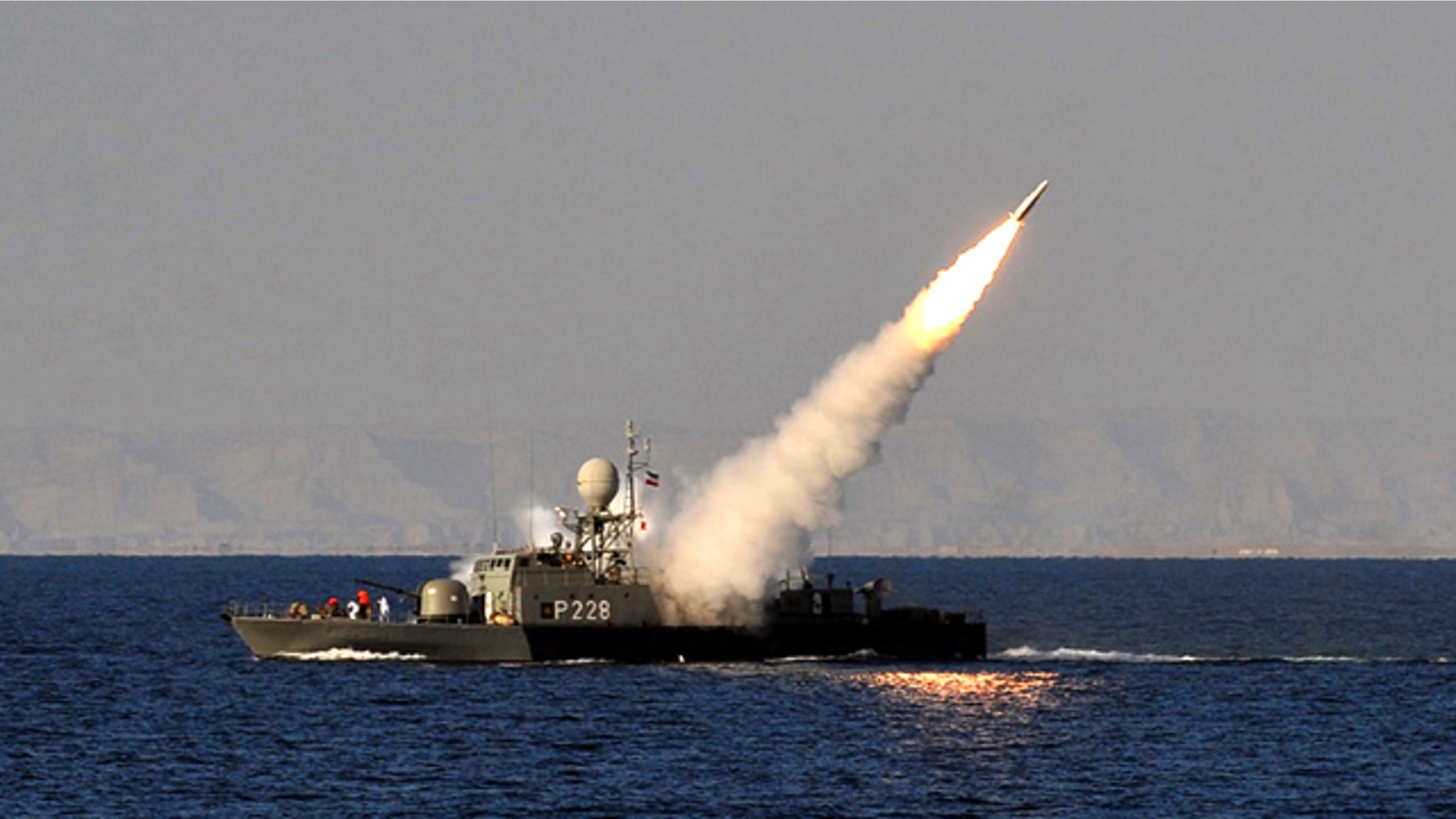 Jan. 1, 2012: In this image made available by the Iranian Students News Agency, an Iranian navy vessel launches a missile during a drill at the sea of Oman.