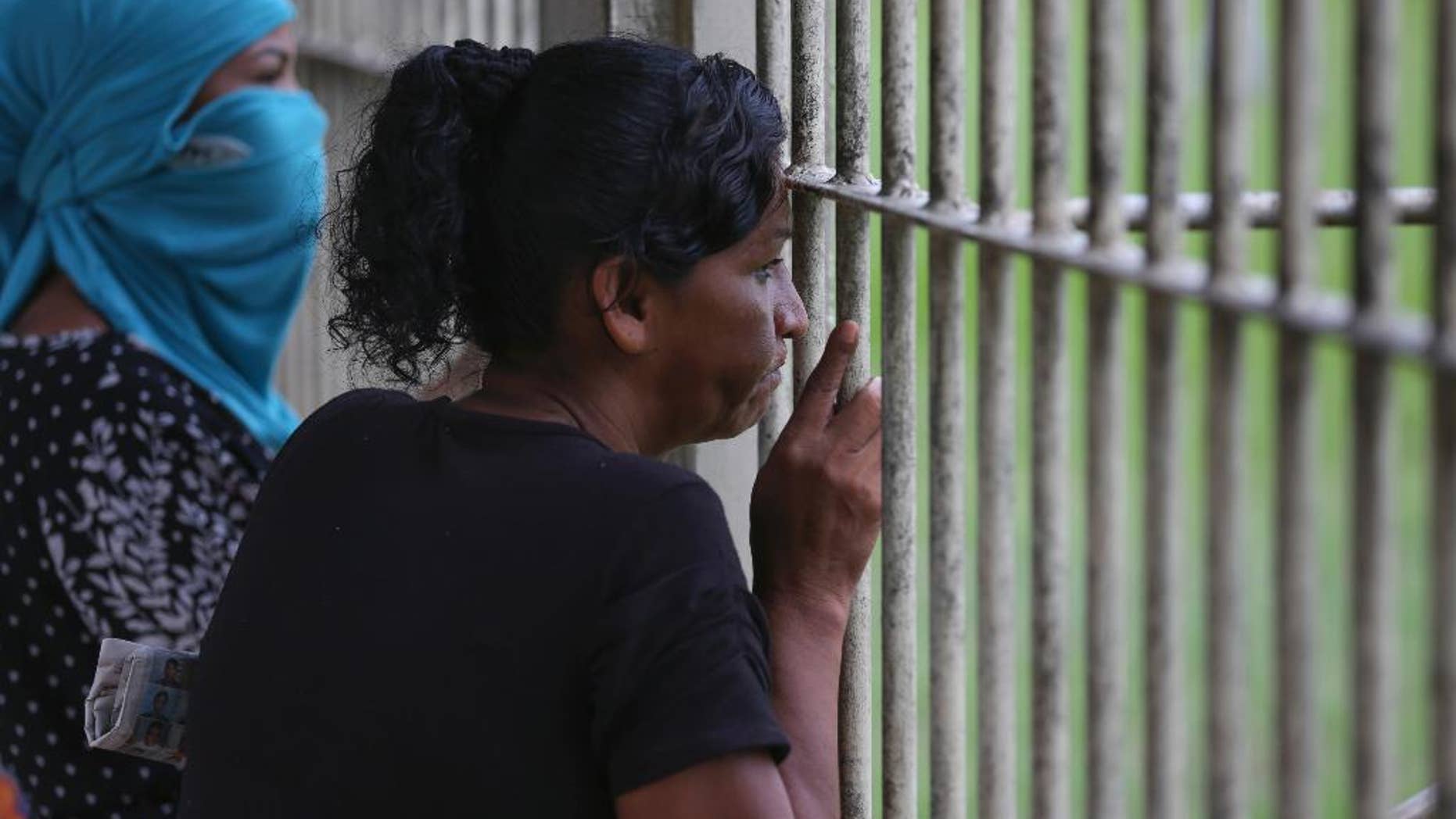 Relatives of prisoners wait to know the names of inmates who died in a riot Tuesday.