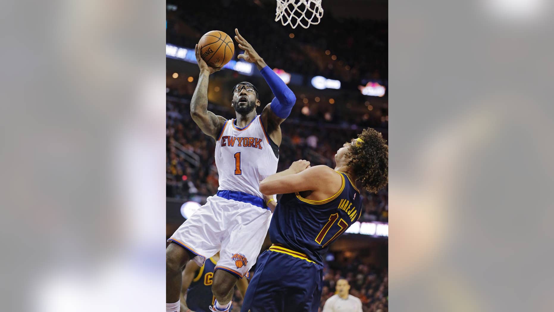 New York Knicks' Amar'e Stoudemire (1) shoots over Cleveland Cavaliers' Anderson Varejao (17), from Brazil, in the second quarter of an NBA basketball game Thursday, Oct. 30, 2014, in Cleveland. (AP Photo/Tony Dejak)