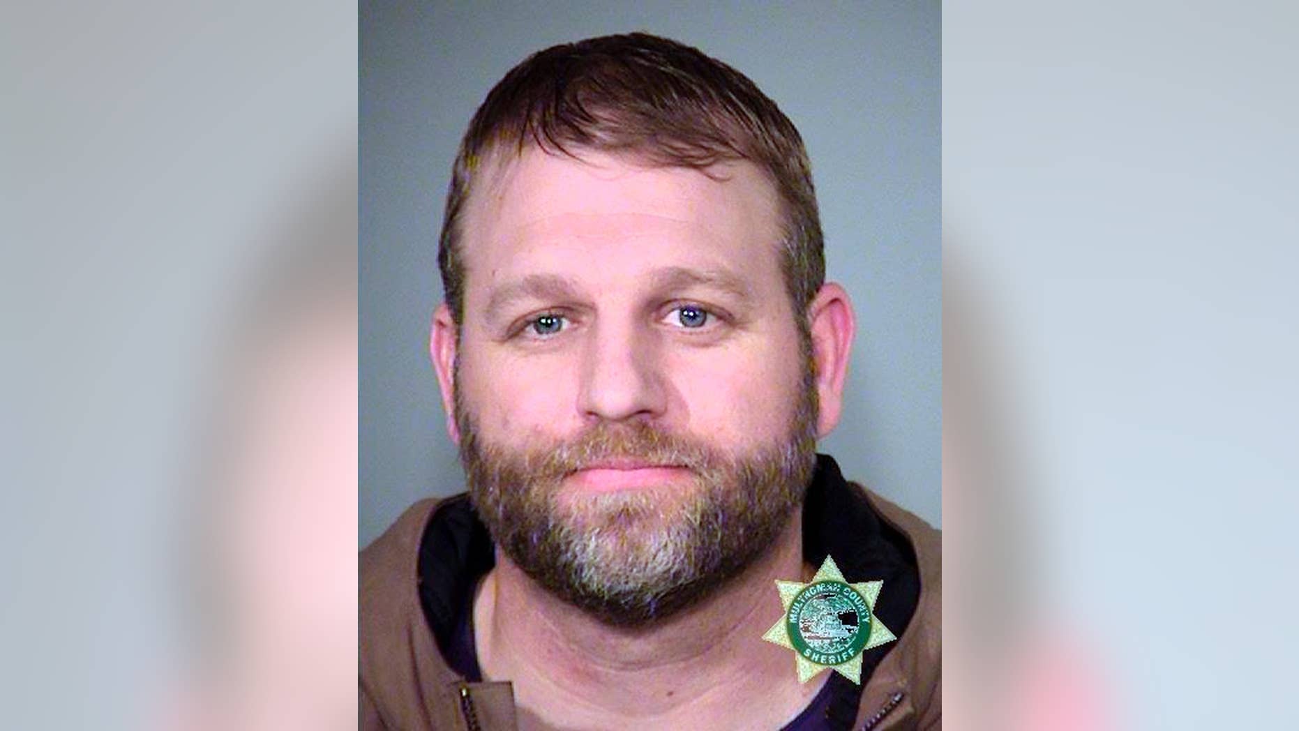 FILE--This Jan. 27, 2016, photo provided by the Multnomah County Sheriff's Office shows Ammon Bundy. Bundy and his brother, Ryan Bundy, are set to go on trial 9 months after the armed occupation of a wildlife refuge in Oregon. Government prosecutors are expected to begin opening statements Tuesday, Sept. 13, 2016, at the federal courthouse in Portland, Ore. (Multnomah County Sheriff via AP, file)