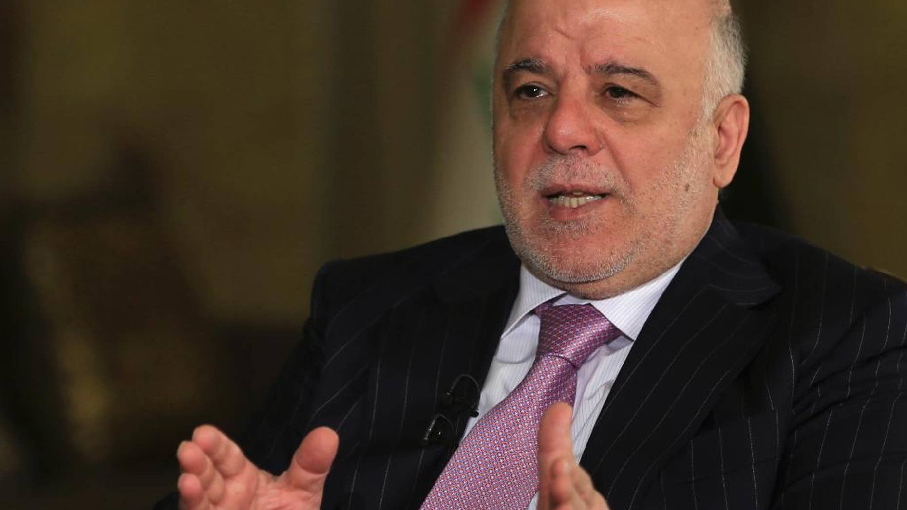 FILE - In this Monday, Nov. 28, 2016, file photo, Iraq's Prime Minister Haider al-Abadi speaks during an interview with the Associated Press in Baghdad. Iraq’s prime minister is demanding full disclosure about events surrounding the 2003 U.S.-led invasion of Iraq. Haider al-Abadi says he would like to see a “thorough investigation” of America’s decision-making that took the U.S. forces from “liberating” the country from “Saddam (Hussein’s) terrorist regime” to “occupying” Iraq. (AP Photo/Khalid Mohammed, File)