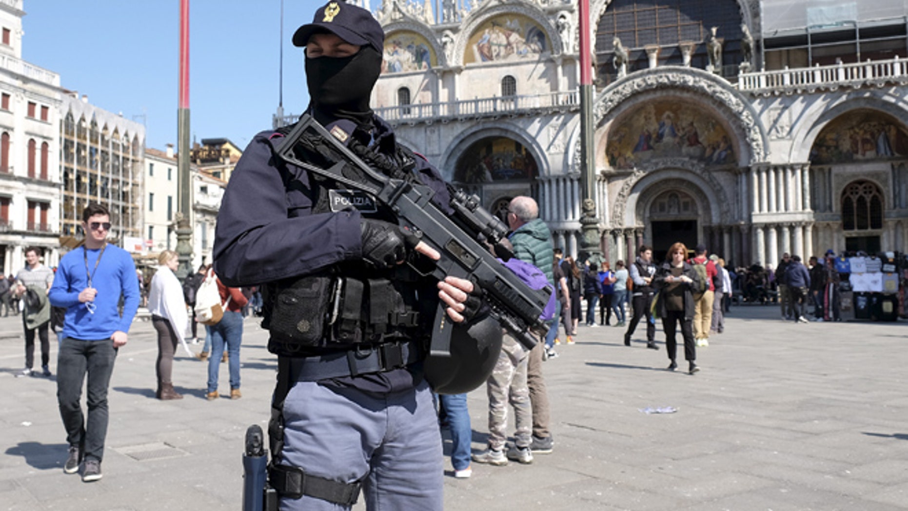 March 24: An Italian masked police officer patrols in St. Mark's square in the Venice lagoon.