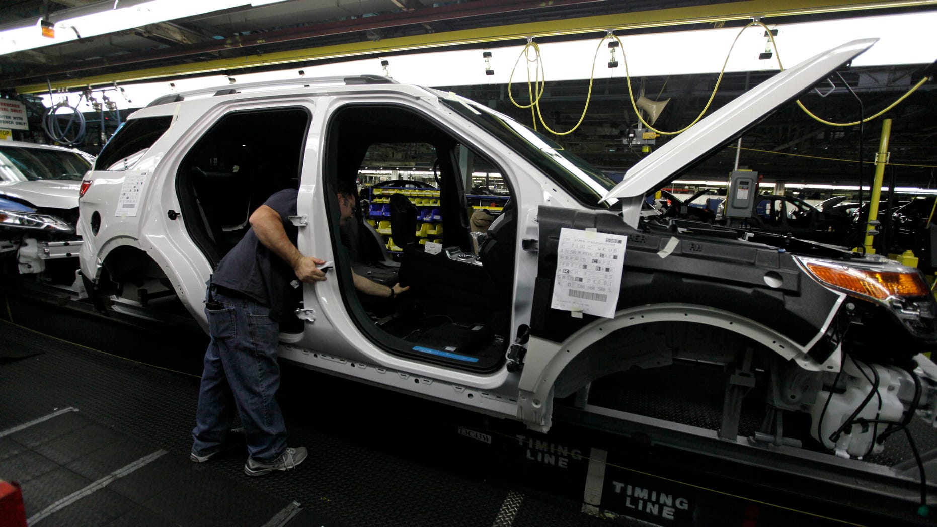FILE - In this Dec. 1, 2010 file photo, plant employees assemble a 2011 Ford Explorer on the assembly line at Ford's Chicago Assembly Plant. Ford Motor Co. said Wednesday, May 22, 2013 that 21 of its North American factories will shut for only one week this summer. That includes the Chicago plant that makes the Ford Explorer SUV and the Mexican plant that makes the Fusion sedan. (AP Photo/M. Spencer Green, File)