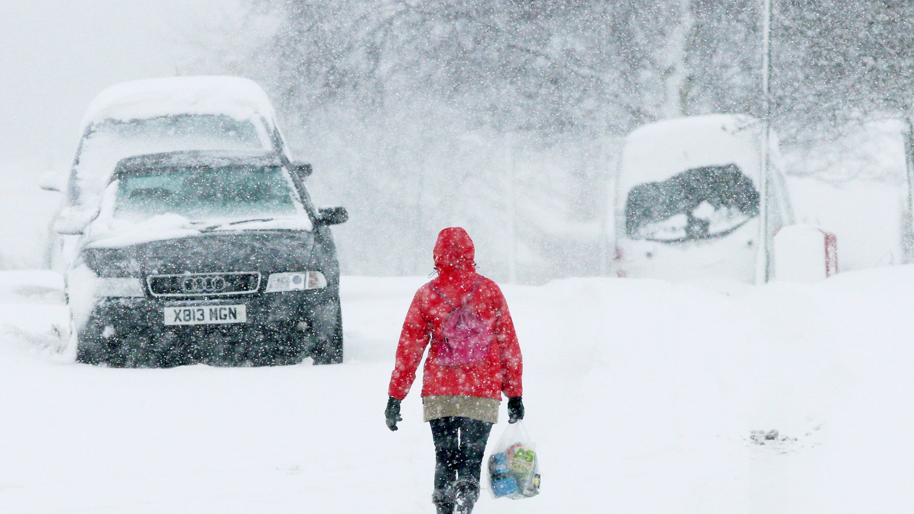 A woman walks through the heavy snow in Stanley, England, Monday, Jan. 21, 2013. The big freeze across Britain is here to stay, with more heavy snow and falling temperatures are forecasted for Britain and Scotland. (AP Photo/Scott Heppell)