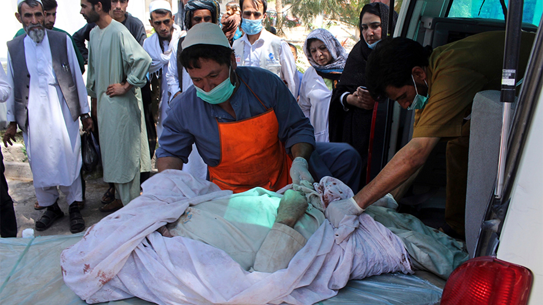 July 31, 2018: Medical personnel transport the body of a bombing victim by ambulance, at a hospital in Herat, Afghanistan.