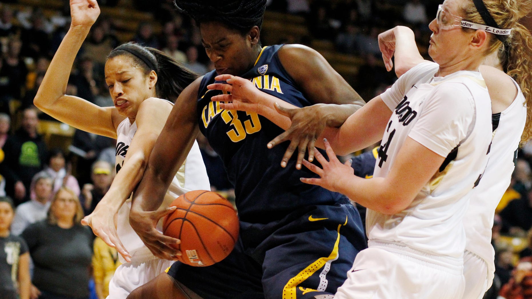 California center Talia Caldwell, center, pulls down a rebound as Colorado forwards Arielle Roberson, left, and Jen Reese cover in the second half of California's 53-49 victory in an NCAA college basketball game in Boulder, Colo., Sunday, Jan. 6, 2013. (AP Photo/David Zalubowski)