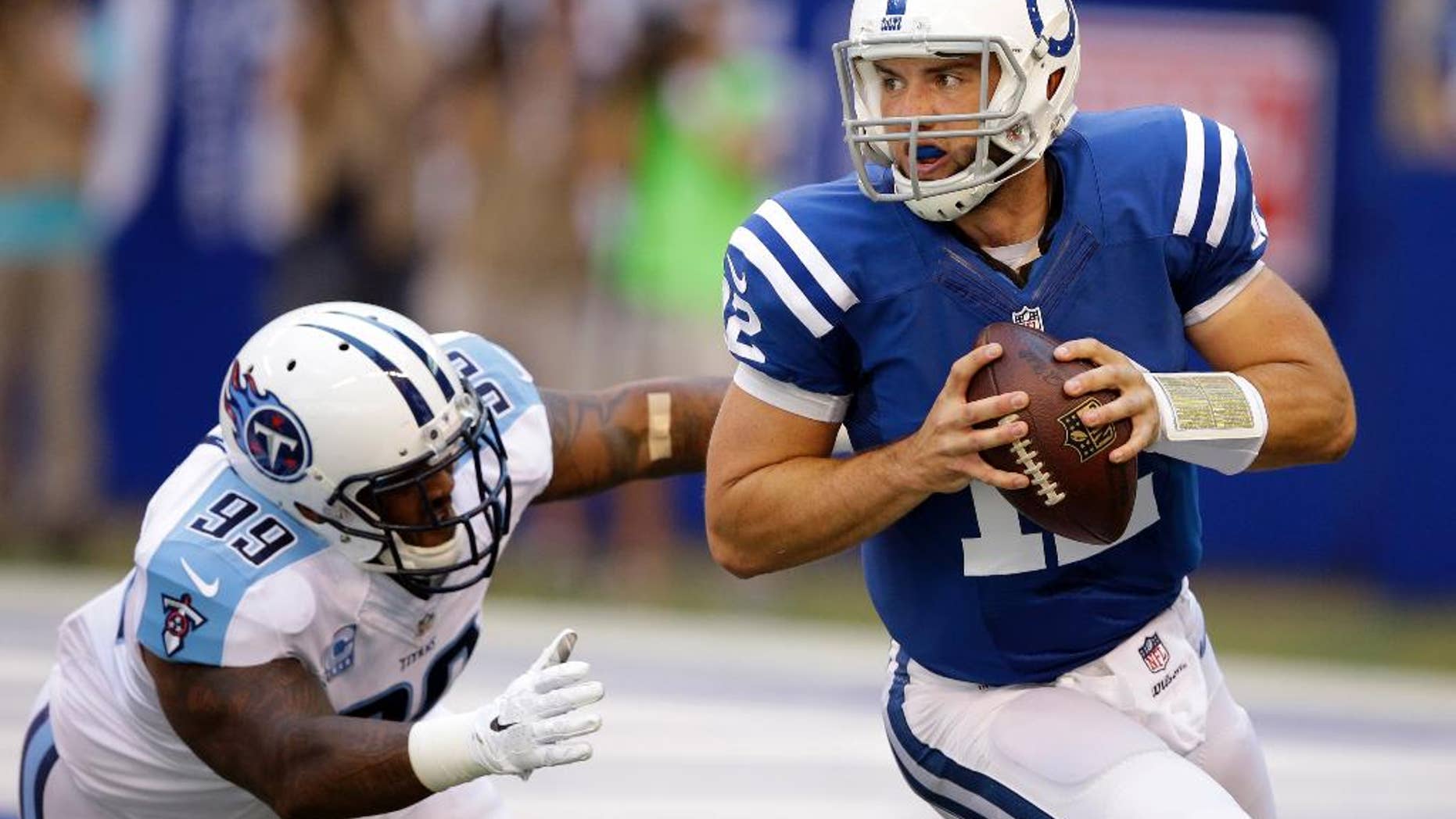 Tennessee Titans defensive end Jurrell Casey, left, chases Indianapolis Colts quarterback Andrew Luck during the first half of an NFL football game in Indianapolis, Sunday, Sept. 28, 2014. (AP Photo/Darron Cummings)