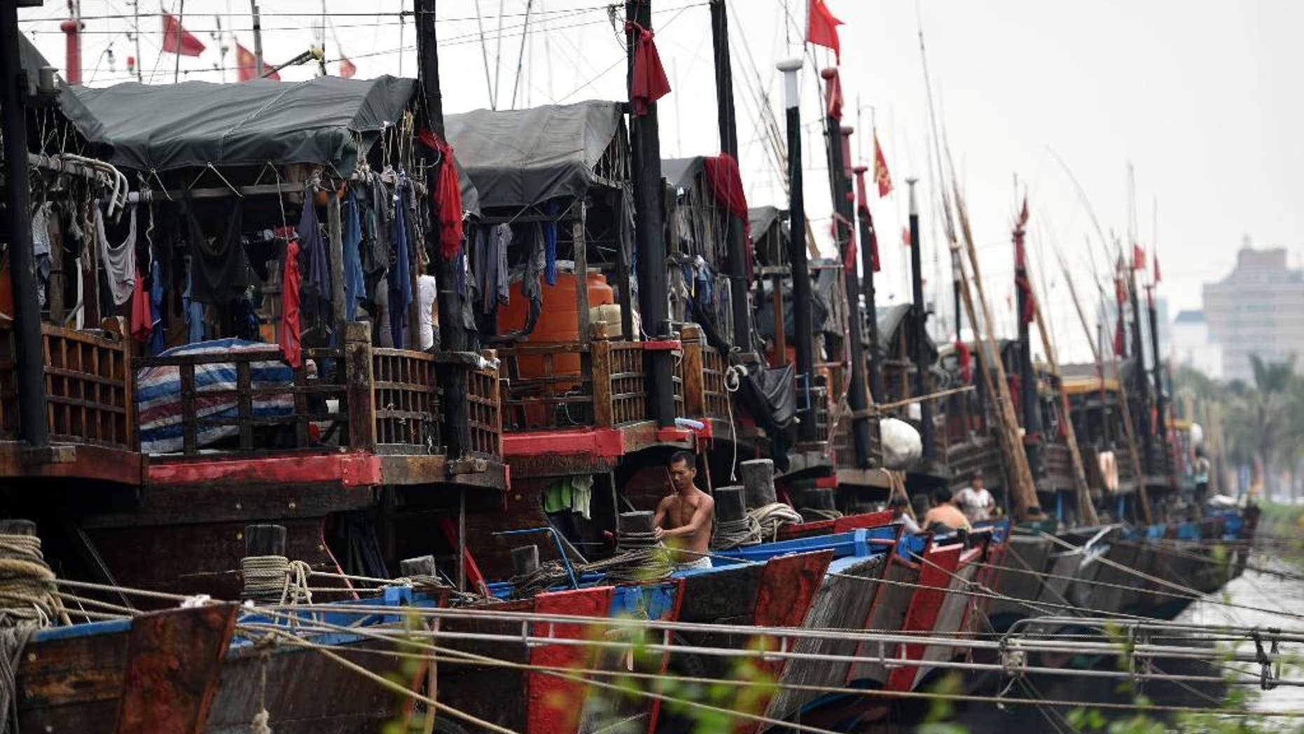 In this Oct. 3, 2015 photo provided by China's Xinhua News Agency, ships berth at Xingang harbor in Haikou, capital of south China's Hainan Province. Tens of thousands of people have been evacuated from coastal areas of southern China, with a strong typhoon that was moving toward the mainland on Sunday, Oct. 4, already bringing powerful winds and heavy rain to the region. Typhoon Mujigae was heading gradually toward the Leizhou Peninsula in Guangdong province, just north of the resort island of Hainan, according to the National Meteorological Center. (Zhao Yingquan/Xinhua News Agency via AP) NO SALES