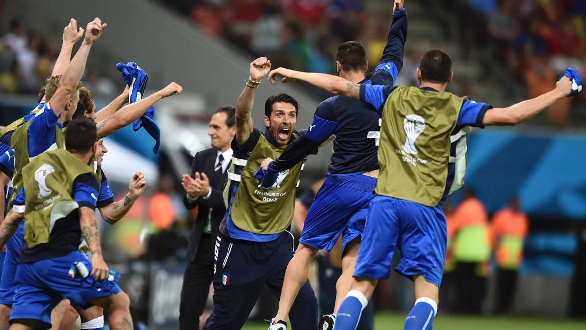 Italian goalie Gianluigi Buffon, face to camera, and coach Cesare Prandelli, center, celebrate with the team after the group D World Cup soccer match between England and Italy at the Arena da Amazonia in Manaus, Brazil, Saturday, June 14, 2014. Italy won the match 2-1. (AP Photo/Fabio Ferrari)