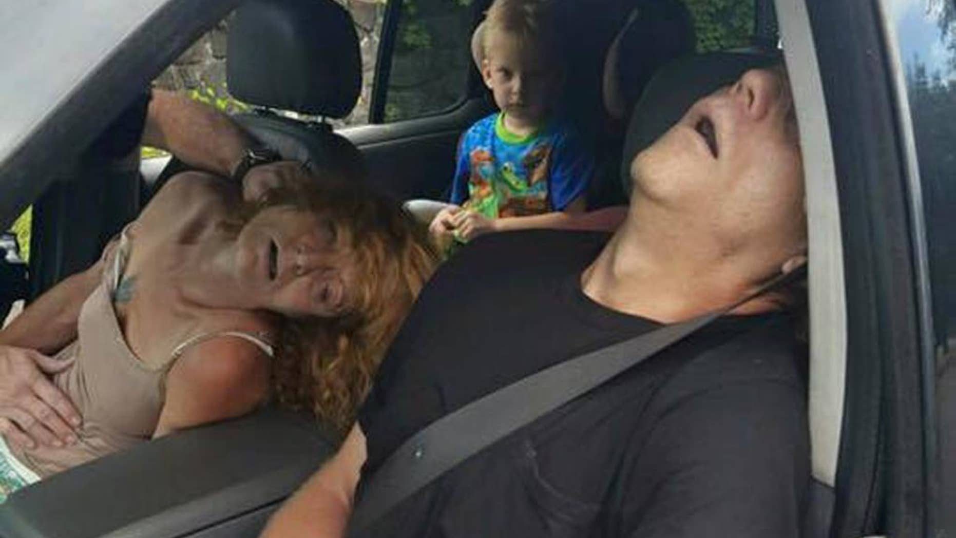FILE - In this Wednesday, Sept. 7, 2016, file photo, released by the East Liverpool Police Department, a young child sits in a vehicle behind his grandmother, Rhonda Pasek and her boyfriend, James Acord, both of whom are unconscious from a drug overdose, in East Liverpool, Ohio. An Ohio judge has turned over the custody of the boy. A Columbiana County Juvenile Court administrator told The Associated Press that the boy’s great uncle and great aunt petitioned the court for custody, which was granted by a judge on Monday, Sept. 12. (East Liverpool Police Department via AP, File)