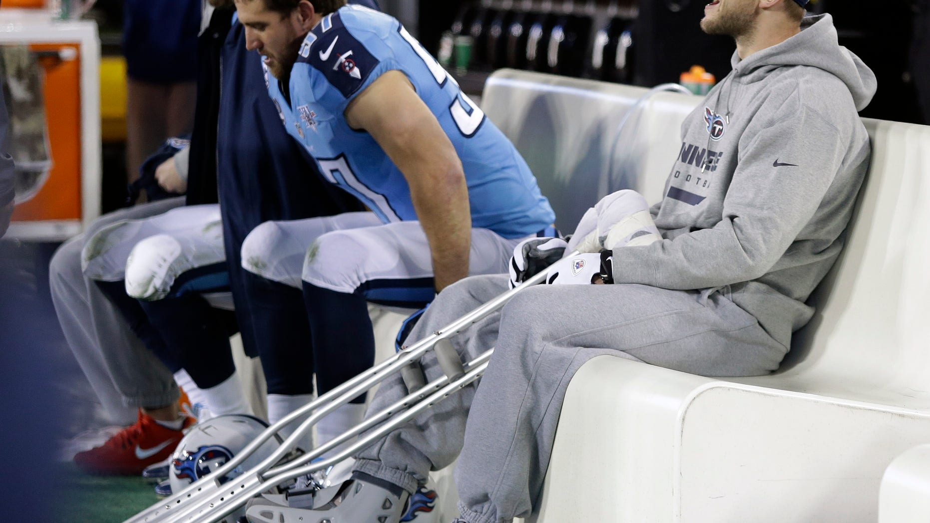Injured Tennessee Titans quarterback Jake Locker sits on the bench in the second quarter of an NFL football game between the Titans and the Indianapolis Colts on Thursday, Nov. 14, 2013, in Nashville, Tenn. (AP Photo/Wade Payne)