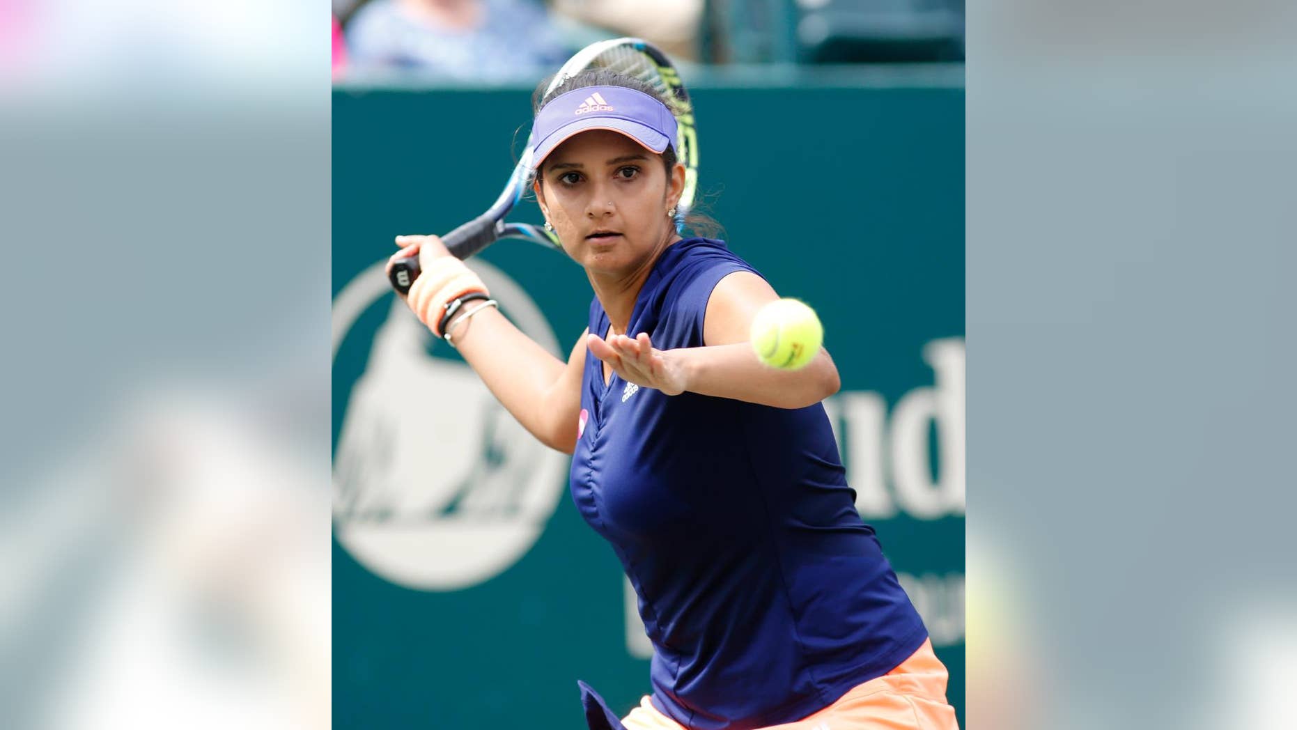 Sania Mirza, of India, returns to Alla Kudryavtseva and Anastasia Pavlyuchenkova during a doubles final match at the Family Circle Cup tennis tournament in Charleston, S.C., Sunday, April 12, 2015. Mirza and Martina Hingis won 6-0, 6-4. (AP Photo/Mic Smith)