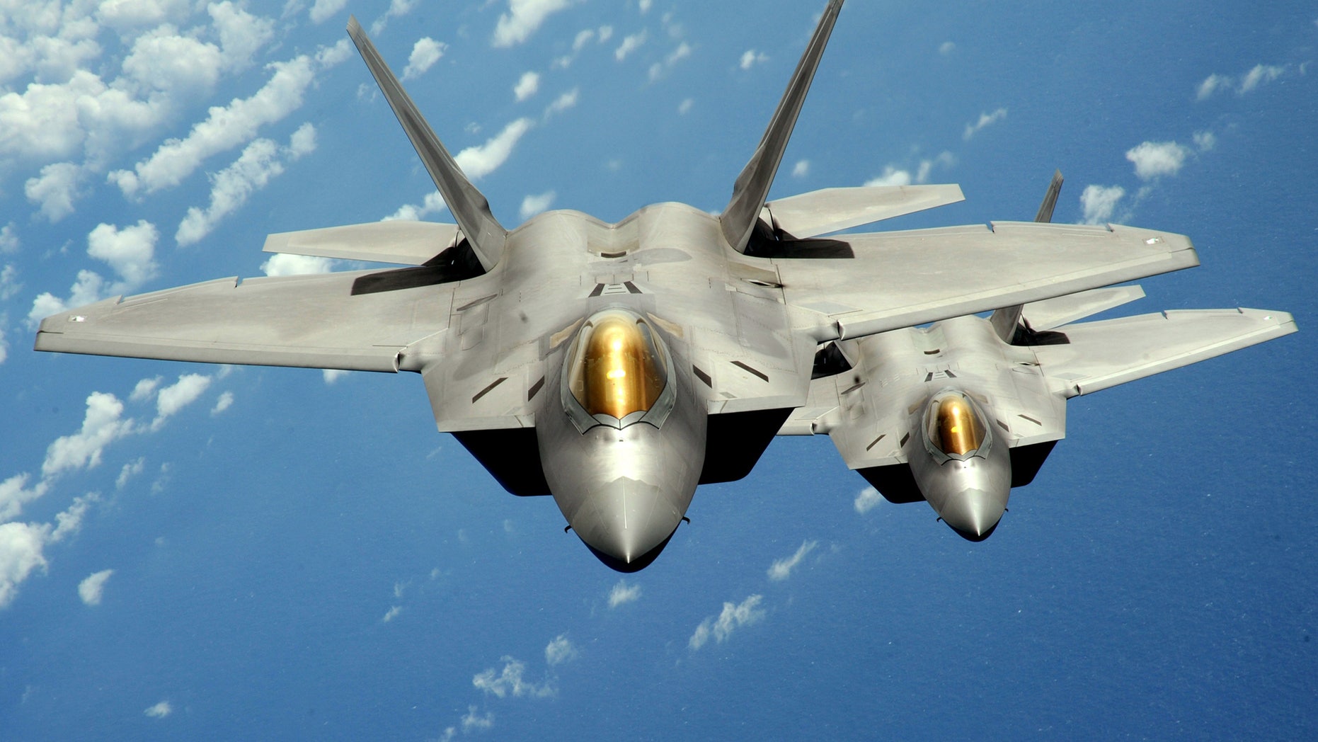 Two U.S. Air Force F-22 Raptor stealth jet fighters fly near Andersen Air Force Base in this handout photo dated August 4, 2010. (REUTERS/U.S. Air Force/Master Sgt. Kevin J. Gruenwald/Handout)