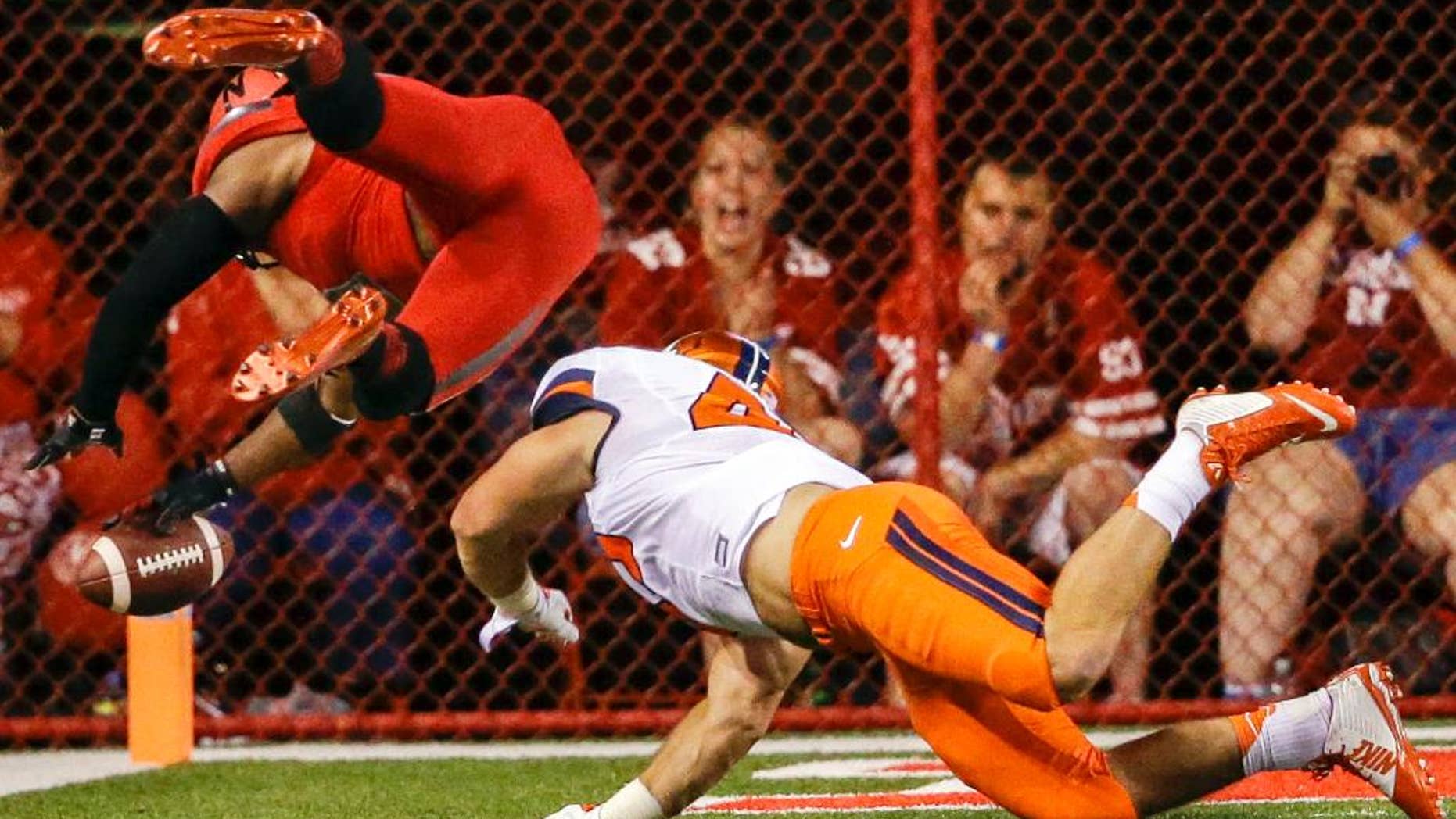 Nebraska running back Ameer Abdullah, left, leaps into the end zone for a touchdown past Illinois linebacker Mason Monheim in the first half of an NCAA college football game in Lincoln, Neb., Saturday, Sept. 27, 2014. (AP Photo/Nati Harnik)