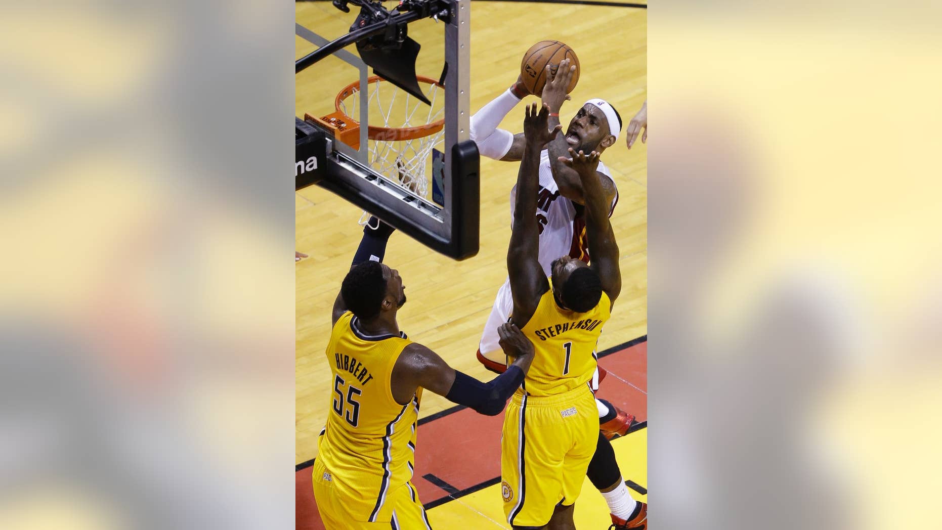 Miami Heat forward LeBron James (6) drives to the basket against Indiana Pacers guard Lance Stephenson (1) and center Roy Hibbert (55) during the first half of Game 3 in the NBA basketball Eastern Conference playoff series, Saturday, May 24, 2014, in Miami. (AP Photo/Wilfredo Lee)