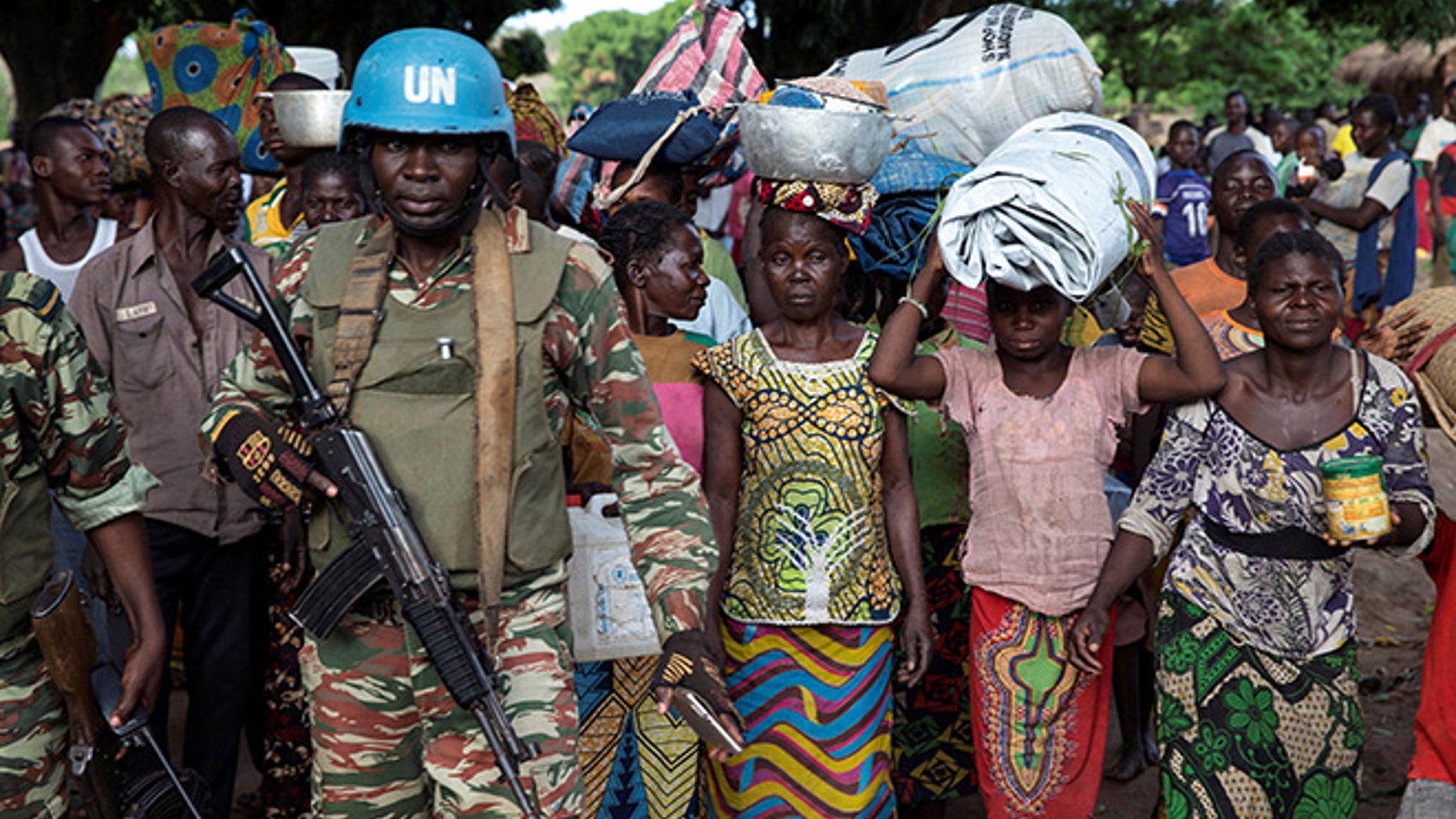 A Cameroonian United Nations peacekeeping soldier guards women fleeing the village of Zike as they arrive to the village of Bambara, Central African Republic, April 25, 2017. Picture taken April 25, 2017. REUTERS/Baz Ratner TPX IMAGES OF THE DAY - RTS143AS