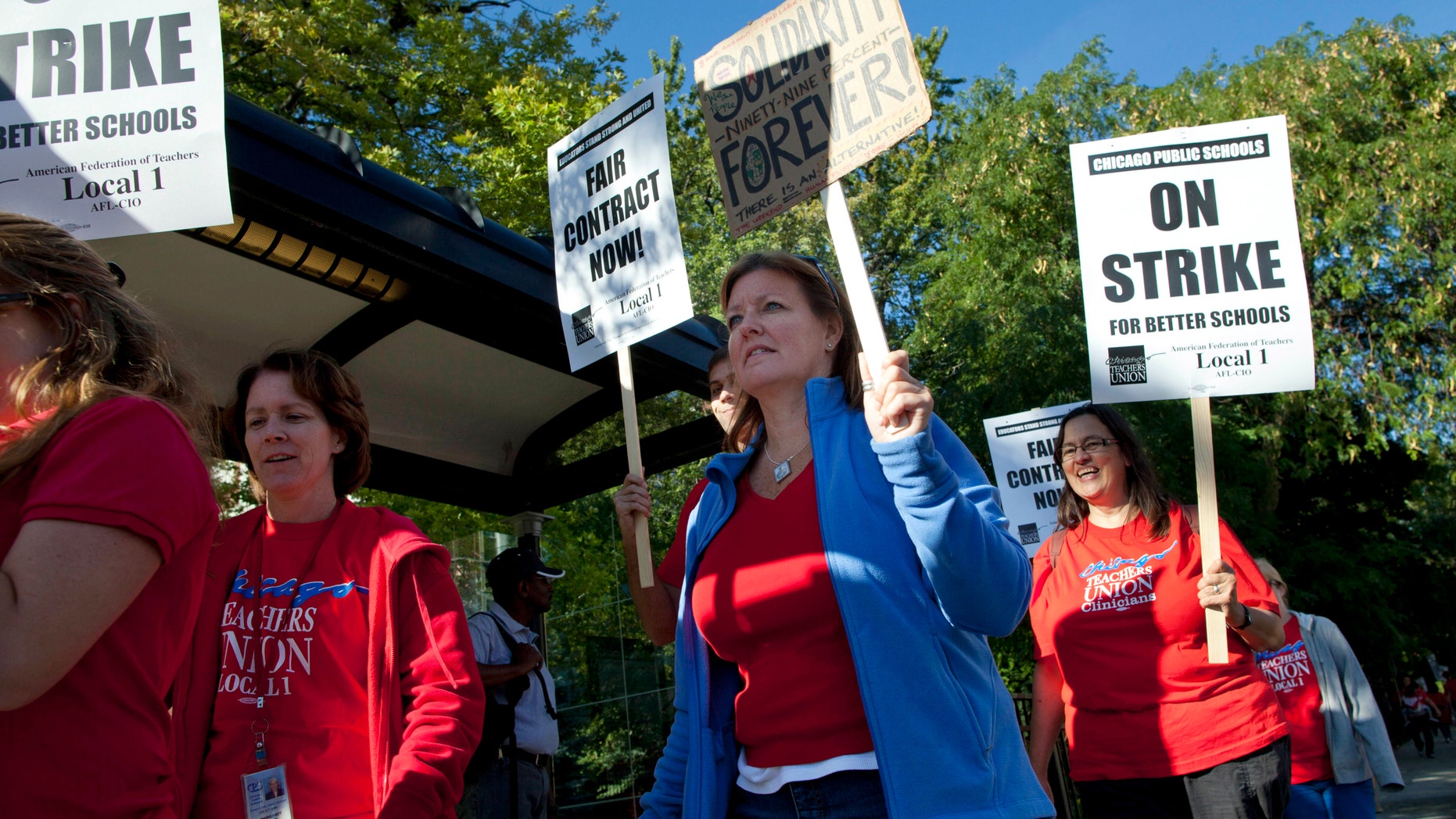 Public school teachers picket outside Amundsen High School on the first day of a strike by the Chicago Teachers Union, Monday, Sept. 10, 2012, in Chicago. (AP Photo/Sitthixay Ditthavong)