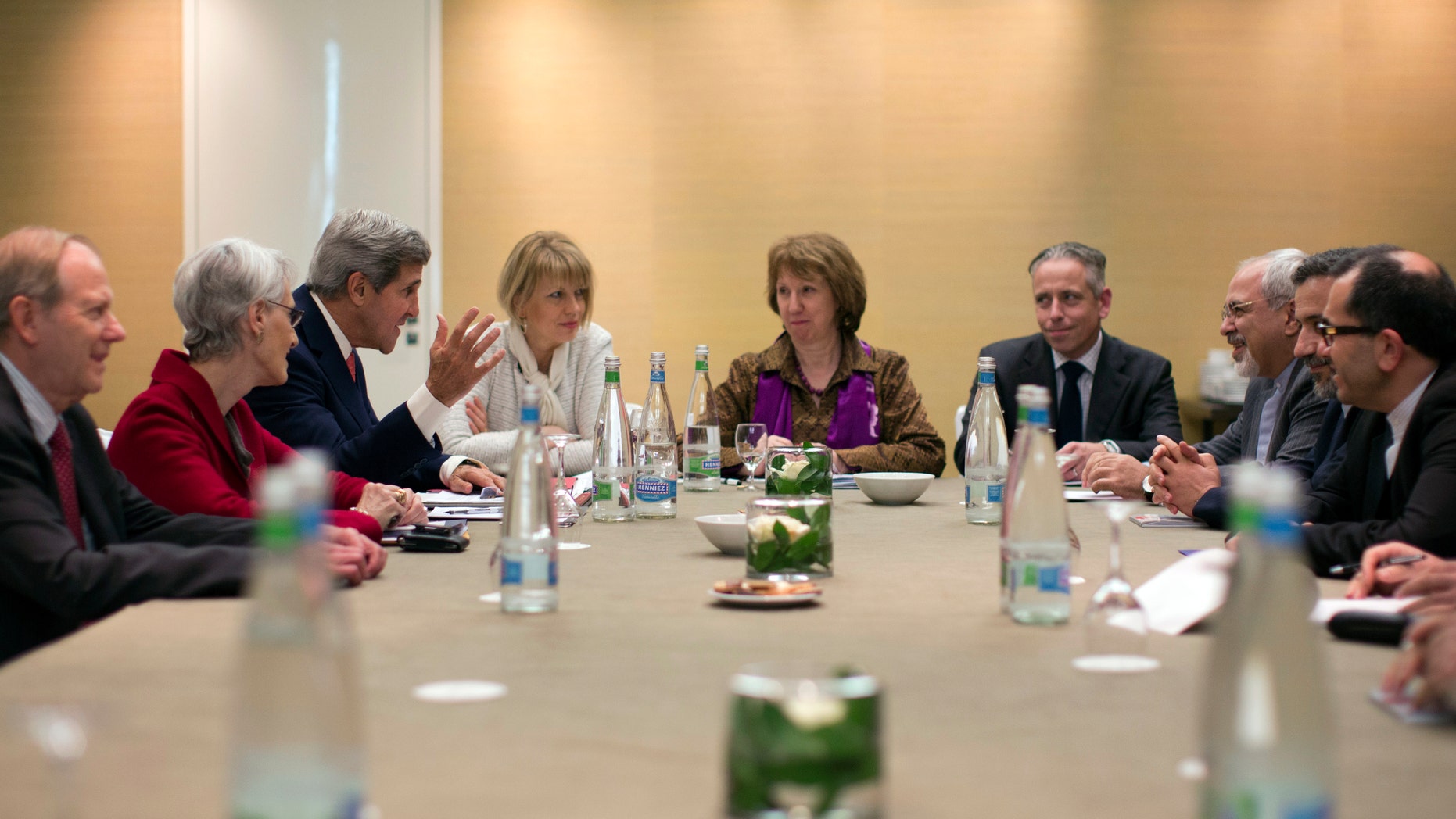 In this Nov. 9, 2013, photo, U.S. Secretary of State John Kerry, third left, meets with EU High Representative for Foreign Affairs, Catherine Ashton, center, and Iranian Foreign Minister Mohammad Javad Zarif, third right, at the Iran Nuclear talks in Geneva, Switzerland. The deadlocked international effort to sign a nuclear deal with Iran has spurred a global blame game over who walked away from the negotiating table and why. It's a war of words playing out in public statements from top officials and across social media, with a bluntness that stands in stark contrast to the secretive and diplomatic nature of the negotiations themselves. And it raises questions about whether the debate will compound the years of mistrust between Iran and the West when the parties reconvene in Geneva for another round of talks next week. (AP Photo/Jason Reed, Pool)