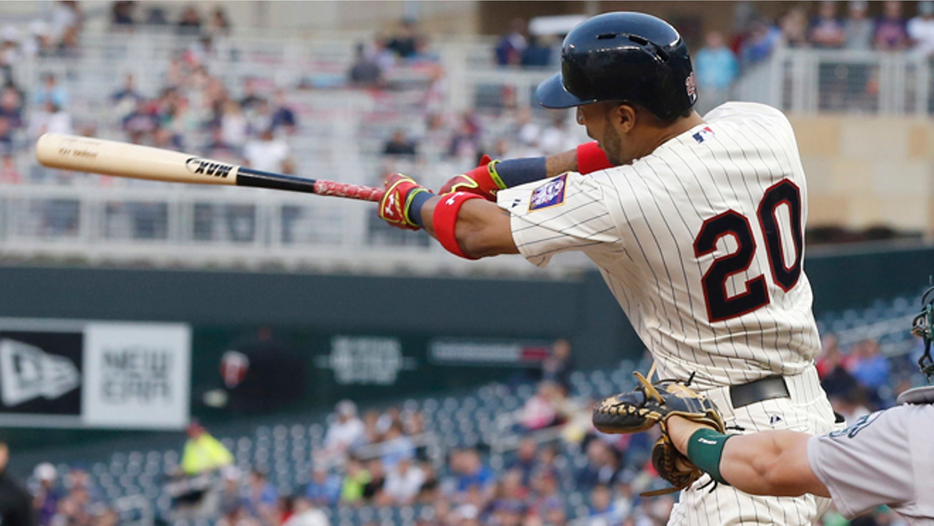 Minnesota Twins' Eddie Rosario hits his first major league home run on the first pitch off Oakland Athletics pitcher Scott Kazmir in the third inning of a baseball game, Wednesday, May 6, 2015, in Minneapolis. (AP Photo/Jim Mone)