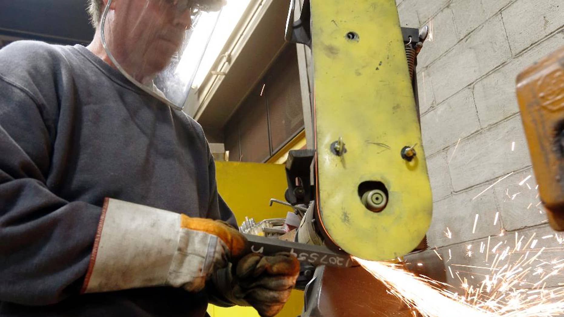 In this photo made on Thursday, Feb. 12, 2015, a workers grinds parts used to build fans for industrial ventilation systems at the Robinson Fans Inc. plant in Harmony, Pa. The Institute for Supply Management, a trade group of purchasing managers, issues its index of manufacturing activity for April on Friday, May 1, 2015. (AP Photo/Keith Srakocic)