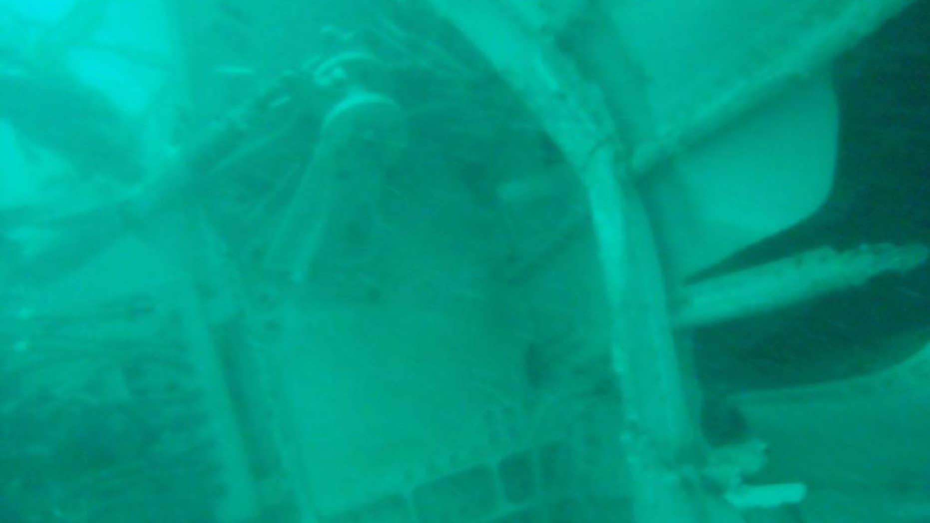 FILE - In this undated underwater file photo released by Indonesia's National Search And Rescue Agency (BASARNAS) on Wednesday, Jan. 7, 2015, the part of the wreckage that BASARNAS identified as of the ill-fated AirAsia Flight 8501, is seen in the waters of the Java Sea, Indonesia. The second attempt to lift the fuselage of the crashed AirAsia jetliner failed Sunday, Jan. 25, 2015 as the wreckage sank back to the ocean floor when a rope linking the lifting balloons broke. Navy spokesman Manahan Simorangkir said strong current was the main obstacle. The rope had been fastened and linked to a ship, but broke again as the fuselage was lifted. (AP Photo/BASARNAS, File)