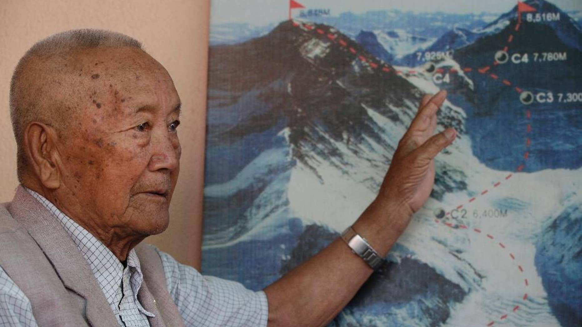 April 11, 2017: Nepalese climber Min Bahadur Sherchan, points to a picture to describe the trail to Mount Everest, as he talks to Associated Press at his residence in Kathmandu, Nepal.