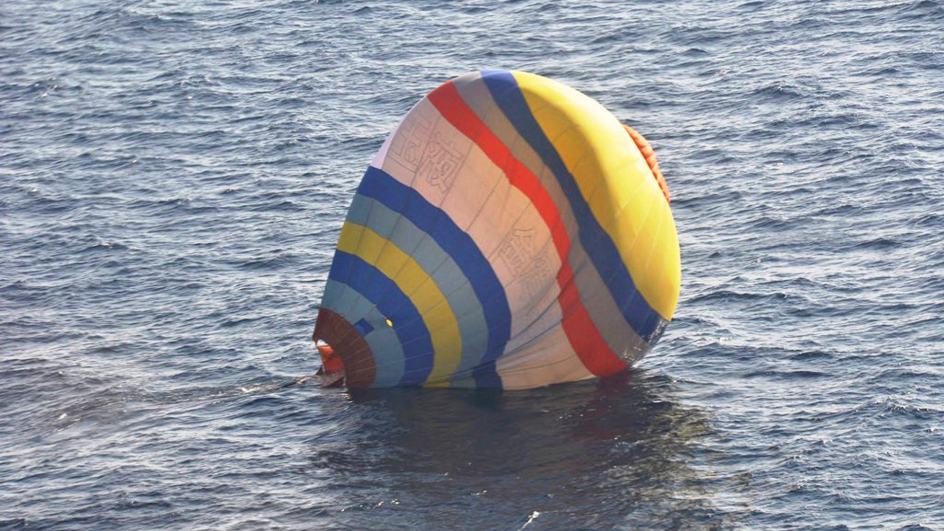 This Wednesday, Jan. 1, 2013 photo released by Japan's 11th Regional Coast Guard shows a hot-air balloon in which the Coast Guard says a Chinese cook took a ride, in waters near the East China Sea islands called Senkaku by Japan and Diaoyu by China. Xu Shuaijun, 35, crashed Wednesday after hitting turbulence as he approached the islands claimed by both China and Japan has been rescued by Japan's Coast Guard after crashing into the sea. (AP Photo/Japan's 11th Regional Coast Guard)