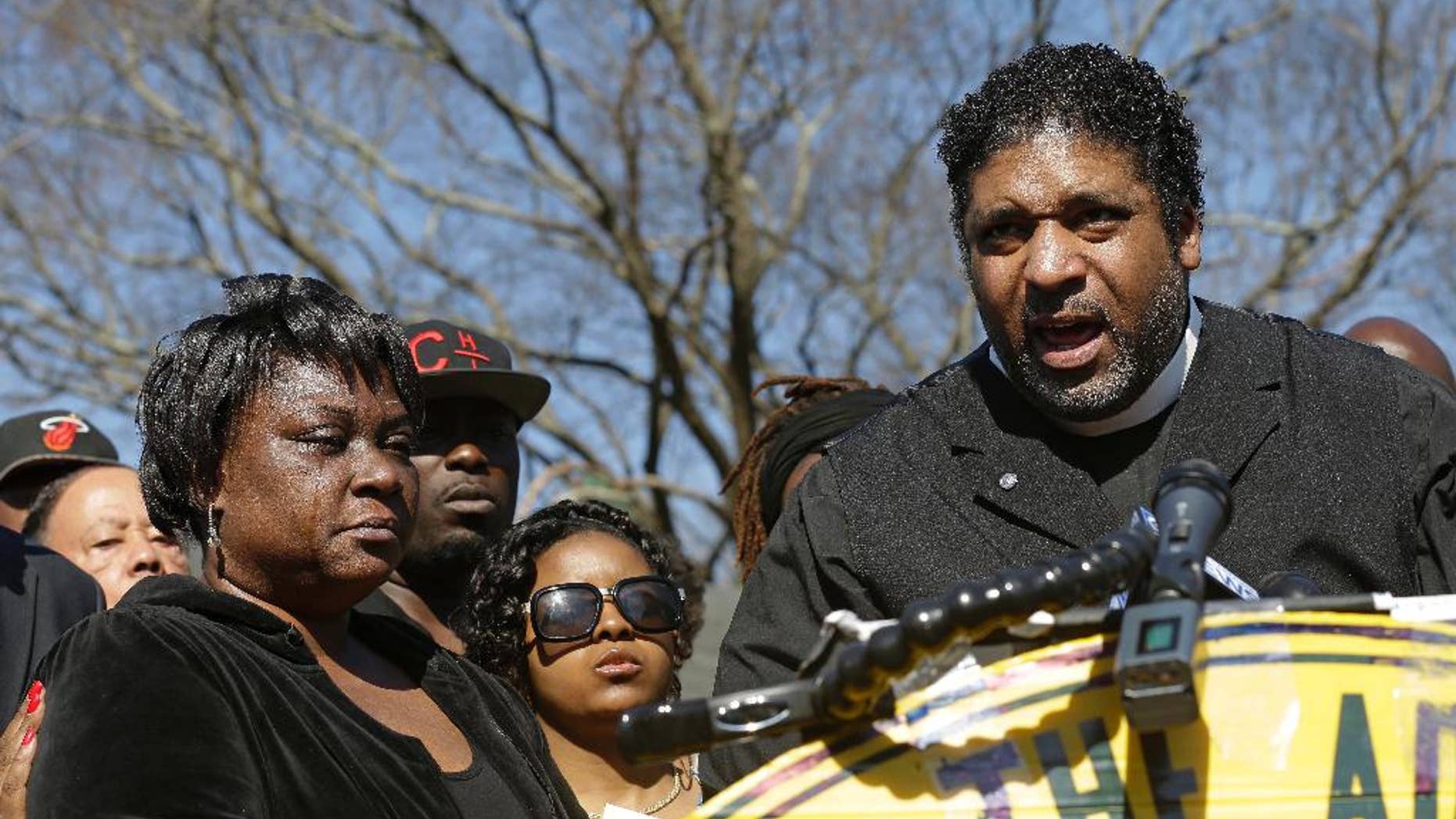FILE - In this March 1, 2016, file photo, The Rev. William Barber II, right, head of the North Carolina National Association for the Advancement of Colored People, speaks during a news conference as Rolonda Byrd, left, who says she is the mother of shooting victim Akiel Denkins, listens near the scene of a shooting in Raleigh, N.C. Barber and the Rev. James Forbes said Monday, March 28, 2016, that they want to encourage people to reclaim political discourse so that it focuses on love, justice and mercy. (AP Photo/Gerry Broome)