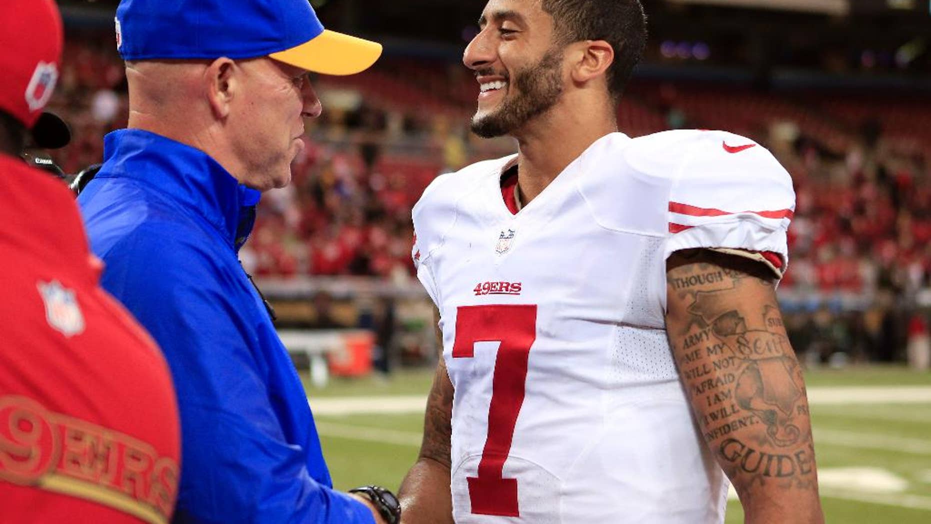 San Francisco 49ers quarterback Colin Kaepernick (7) shakes hands with St. Louis Rams defensive line coach Mike Waufle after the 49ers beat the Rams in an NFL football game Monday, Oct. 13, 2014, in St Louis. The 49ers won 31-17. (AP Photo/Billy Hurst)