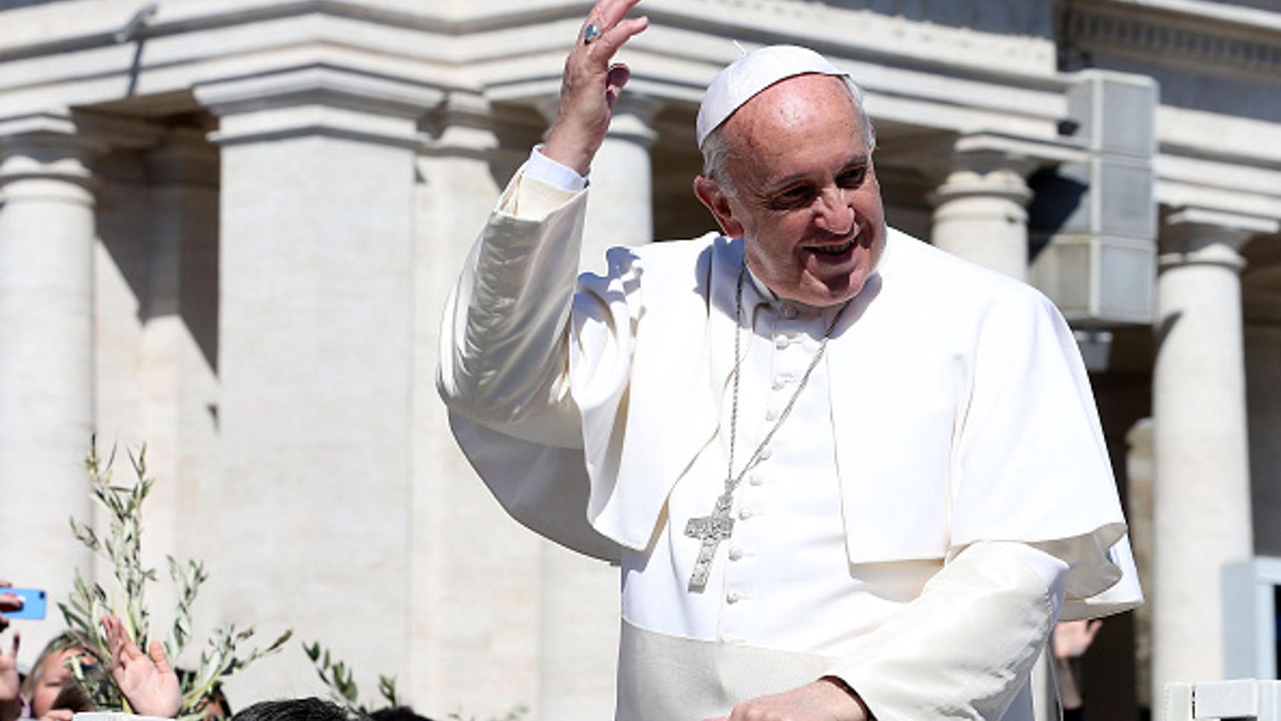 VATICAN CITY, VATICAN - MARCH 29: Pope Francis waves to the faithful as he leaves St. Peter's Square at the the end of Palm Sunday Mass on March 29, 2015 in Vatican City, Vatican. On Palm Sunday Christians celebrate Jesus' arrival into Jerusalem, where he was put to death. It marks the official beginning of Holy Week during which Christians observe the death of Christ before celebrations begin on Easter. (Photo by Franco Origlia/Getty Images)