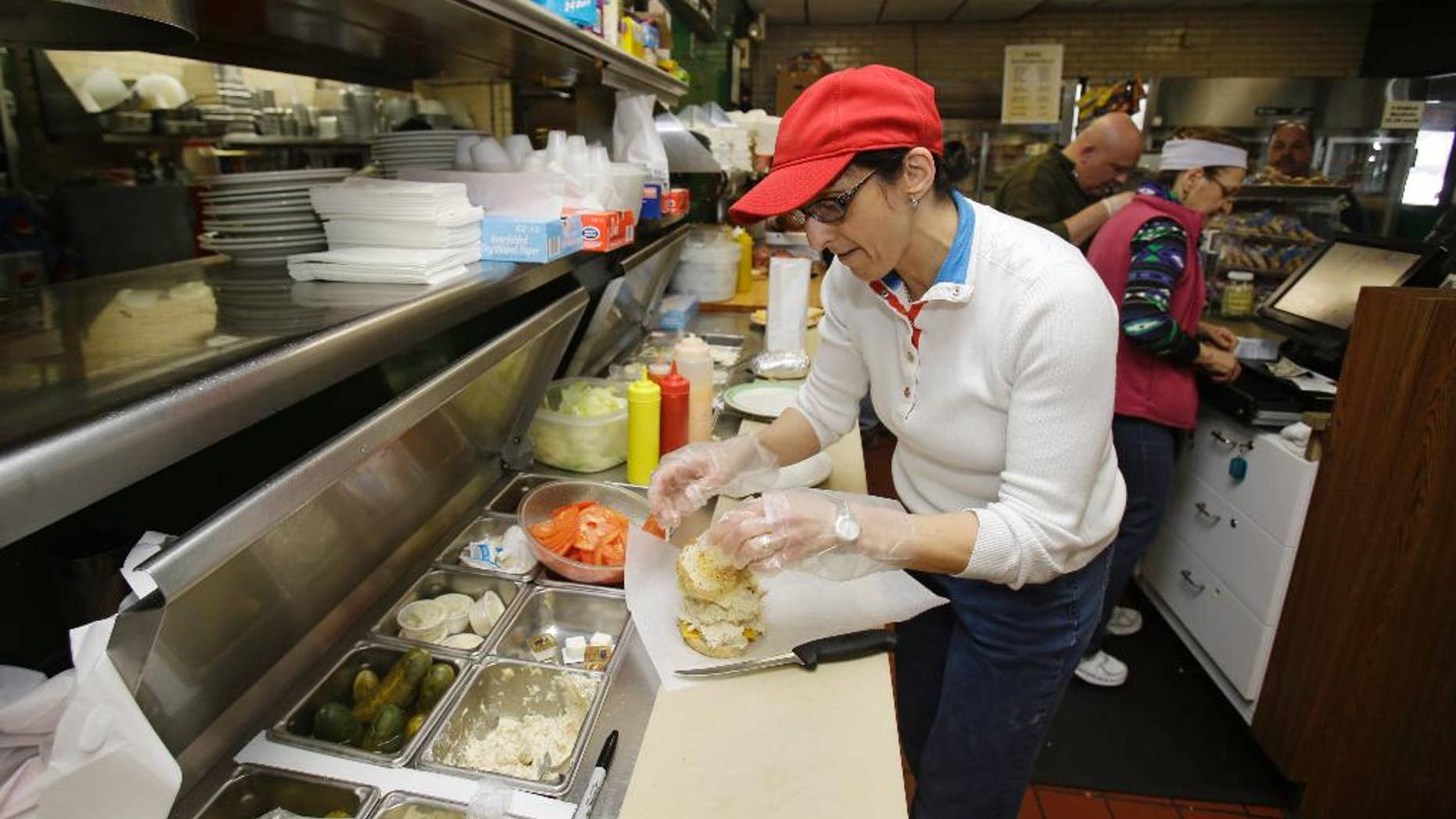 In this Friday, Jan. 23, 2015 photo, Collett Elkhouria makes a chicken salad sandwich the Superior Restaurant in Cleveland. The Institute for Supply Management releases its service sector index for February on Wednesday, March 4, 2015. (AP Photo/Tony Dejak)