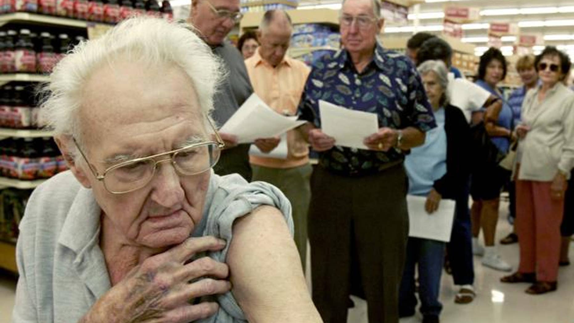 Pete Jacksen, 86, waits in line to get a flu shot at Pavilions pharmacy in Monrovia, Calif., Thursday, Oct. 7, 2004. Health officials nationwide are urging healthy adults and schoolchildren to skip the shot because British regulators have shut down the major flu-shot supplier Chiron on Tuesday, citing manufacturing problems.(AP Photo/Nick Ut)