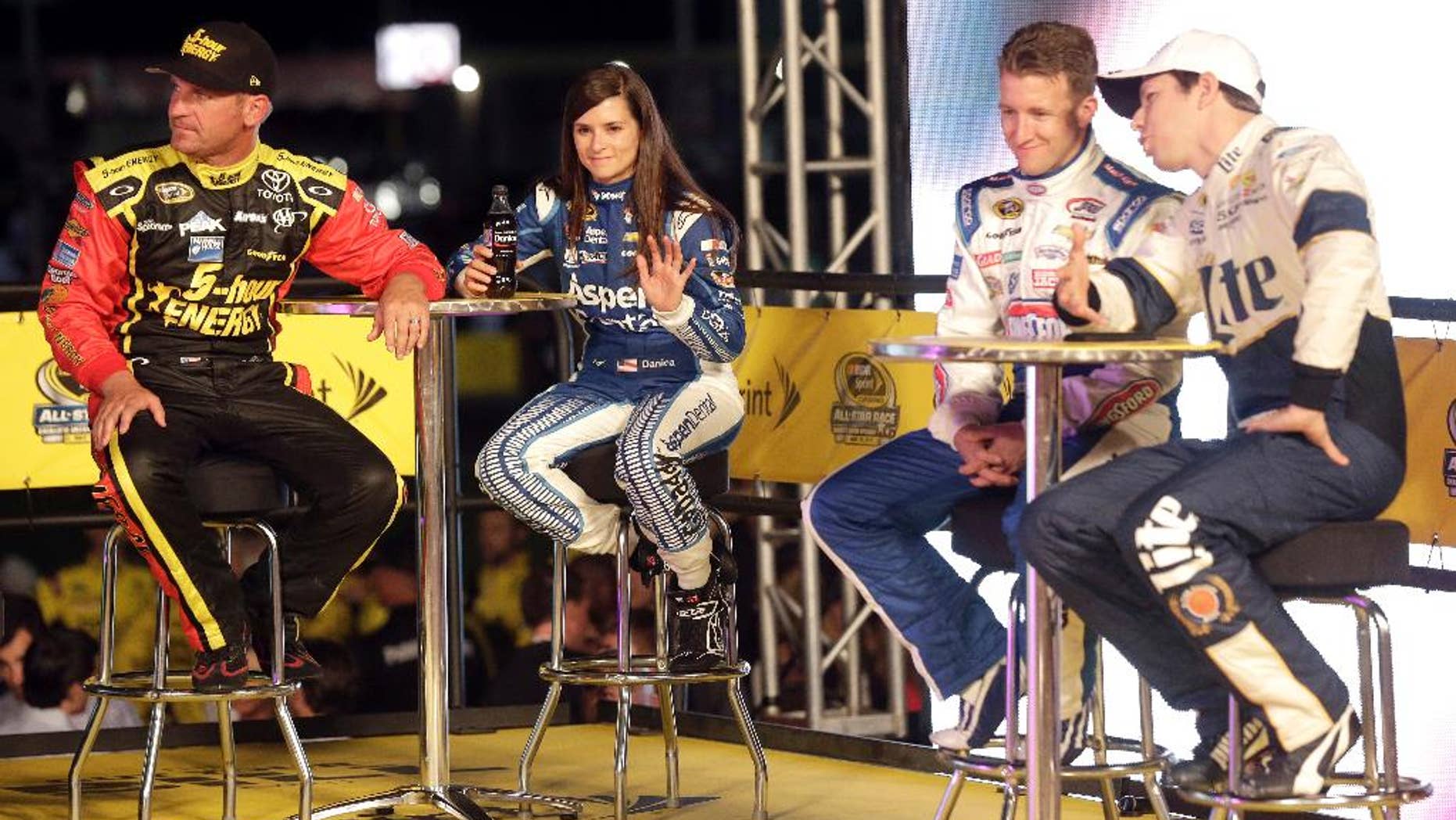 Clint Bowyer, Danica Patrick, AJ Allmendinger and Brad Keselowski, from right, watch during driver introductions prior to the NASCAR Sprint All-Star auto race at Charlotte Motor Speedway in Concord, N.C., Saturday, May 16, 2015. (AP Photo/Gerry Broome)