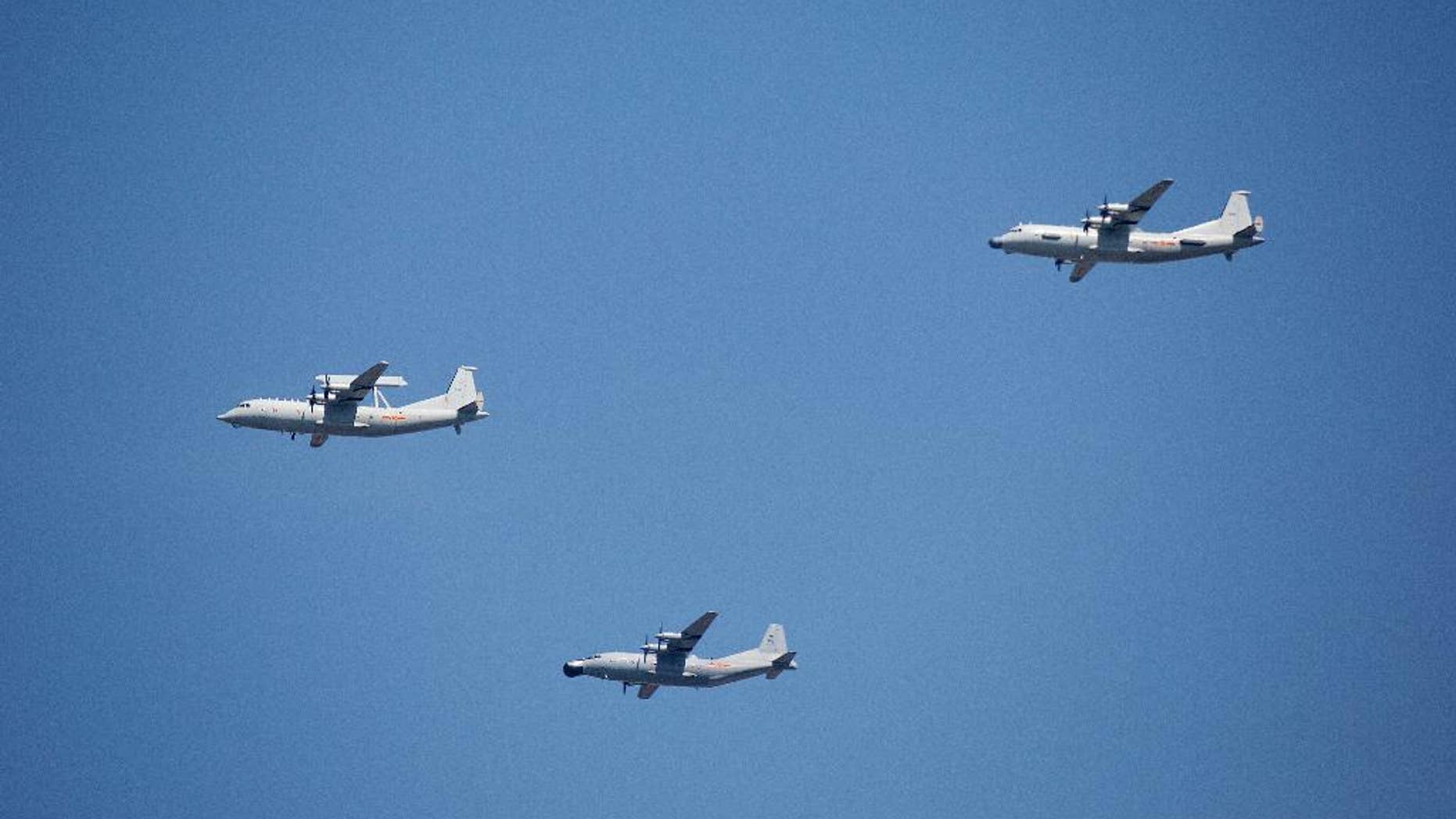 FILE - In this Sept. 3, 2015 file photo, a KJ-200 airborne early warning and control plane, left, a Y-8J radar plane, center, and a Y-9JB radar plane, right, fly in formation during a parade commemorating the 70th anniversary of Japan's surrender during World War II in Beijing. The U.S. Pacific Command says a Chinese aircraft and a U.S. Navy patrol plane had an "unsafe" encounter over the South China Sea this week, raising concerns. Pacific Command spokesman Robert Shuford said Friday, Feb. 10, 2017, that the "interaction" between a Chinese KJ-200 early warning aircraft and a U.S. Navy P-3C plane took place on Wednesday, Feb. 8, in international airspace over the waters. (AP Photo/Mark Schiefelbein, File)