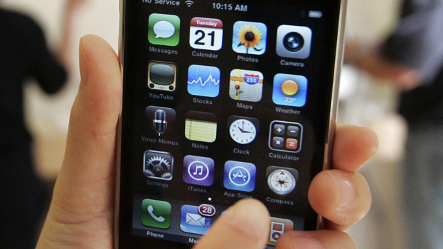 FILE - In this July 21, 2009 file photo, a customer displays an Apple iPhone 3GS at an Apple store in Palo Alto, Calif. Apple Inc. shares have hit another all-time high Tuesday, March 30, 2010, now that it appears the iPhone could find a new sales outlet through Verizon Wireless. (AP Photo/Paul Sakuma, File)