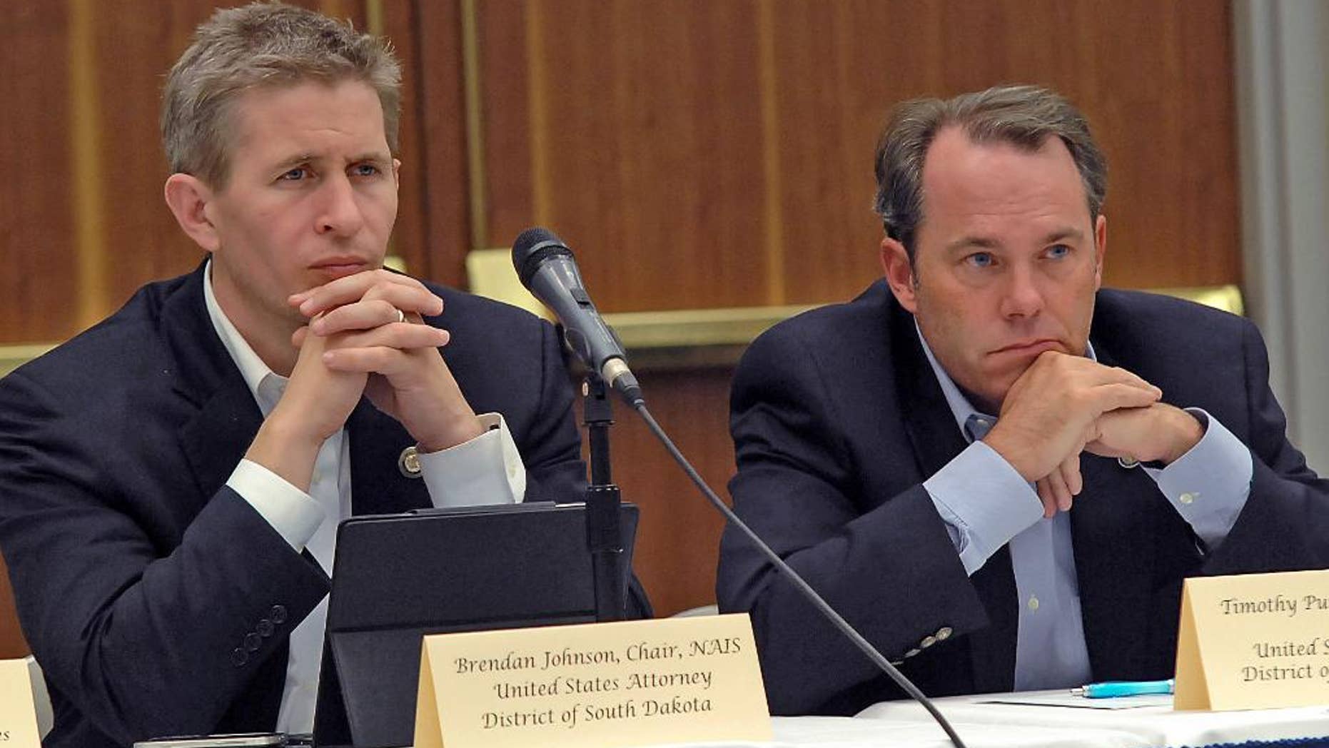 FILE - In this Sept. 6, 2012, file photo, Brendan Johnson, left, and Timothy Purdon, the U.S. Attorneys for South Dakota and North Dakota, respectively, listen to testimony about law enforcement on the Fort Berthold Indian Reservation, N.D. The U.S. attorney for South Dakota plans to resign and open an office in Sioux Falls for a private law firm that has also hired North Dakota’s U.S. attorney to start a practice in Bismarck, a source confirmed to The Associated Press late Tuesday, Feb. 17, 2015. (AP Photo/The Bismarck Tribune, Tom Stromme, File)