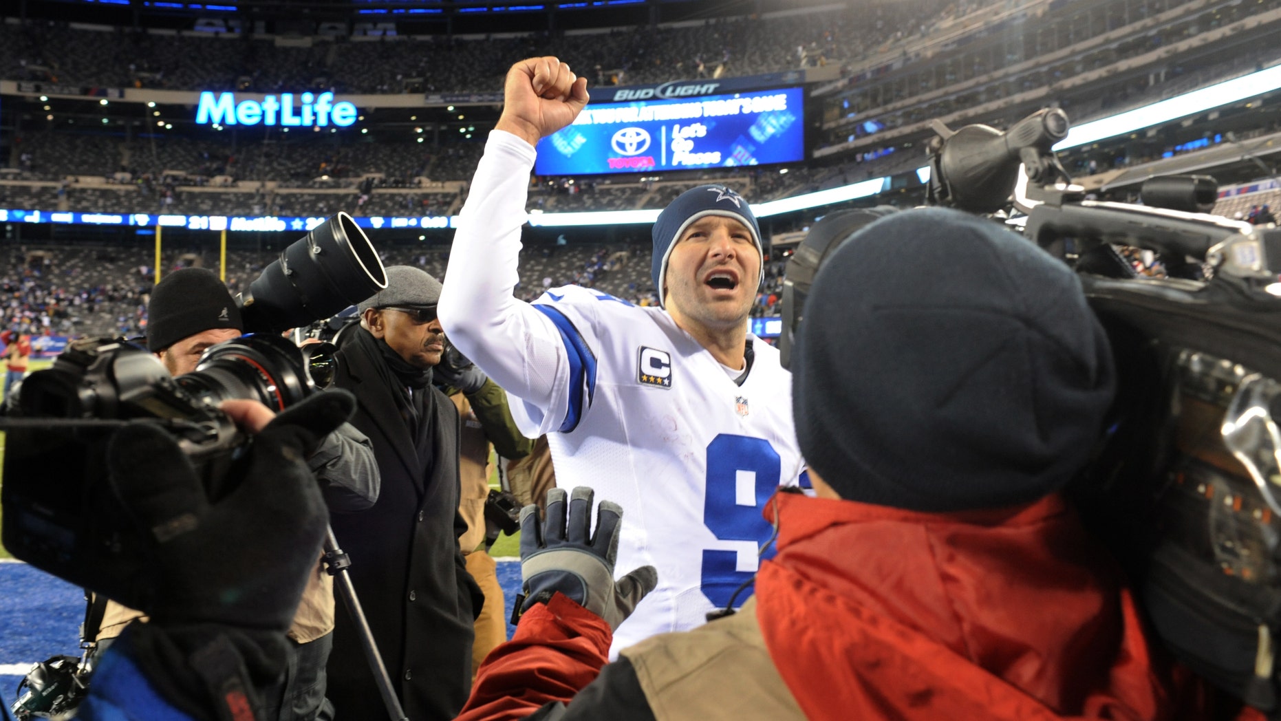 File - In this Nov. 24, 2013 file photo, Dallas Cowboys quarterback Tony Romo (9) gestures while leaving the field after defeating the New York Giants 24-12 in an NFL football game, in East Rutherford, N.J. The winter blast that hit North Texas forced the Cowboys indoors when they were hoping to keep working outside in preparation for a bitterly cold Monday night in Chicago. The Cowboys don’t mind practicing in the elements because it worked pretty well leading up to a frigid win at the New York Giants two weeks ago. (AP Photo/Bill Kostroun, File)