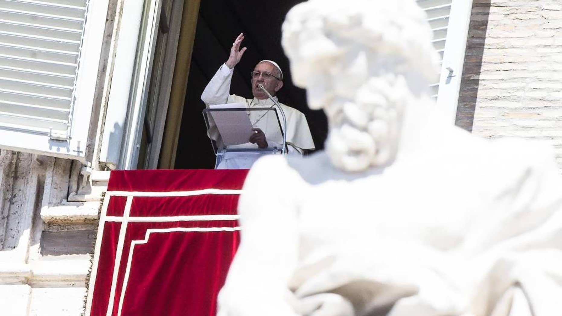 Pope Francis waves to faithful from the window of his studio overlooking St. Peter's Square, at the Vatican Monday, Aug. 15, 2016. Pope Francis is urging people to think about the plight of women who are “slaves of the arrogance of the powerful” as well as children forced to do “inhumane” work. In remarks to tourists and pilgrims in St. Peter’s Square Monday, Francis decried that some women “are obliged to surrender in body and spirit to the covetousness of men.” (Angelo Carconi/ANSA via AP)