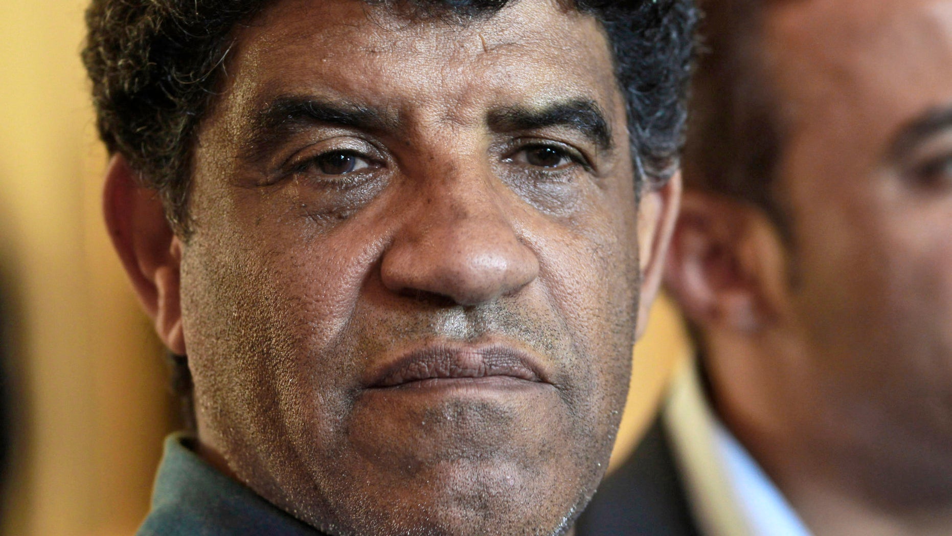 FILE - In this Sunday, Aug. 21, 2011 file photo Abdullah al-Senoussi, head of Libyan intelligence, speaks to the press in Tripoli, Libya. In a surprise decision, judges at the International Criminal Court (ICC) ruled Friday, Sept. 11, 2013, one of the most prominent members of slain dictator Moammar Gadhafiís regime should be tried for war crimes at home, essentially saying they think Libyaís legal system is fair and functional enough to handle a complex trial. The pretrial chamber at the Hague, Netherlands-based court said in its ruling Libyan authorities are ìwilling and ableî to prosecute former intelligence chief Abdullah al-Senoussi, and therefore he cannot be tried at the ICC. Al-Senoussi is accused of alleged crimes against humanity for the murder and persecution of protesters in the early days of the uprising that eventually toppled Gadhafi in 2011. (AP Photo/Dario Lopez-Mills, File)