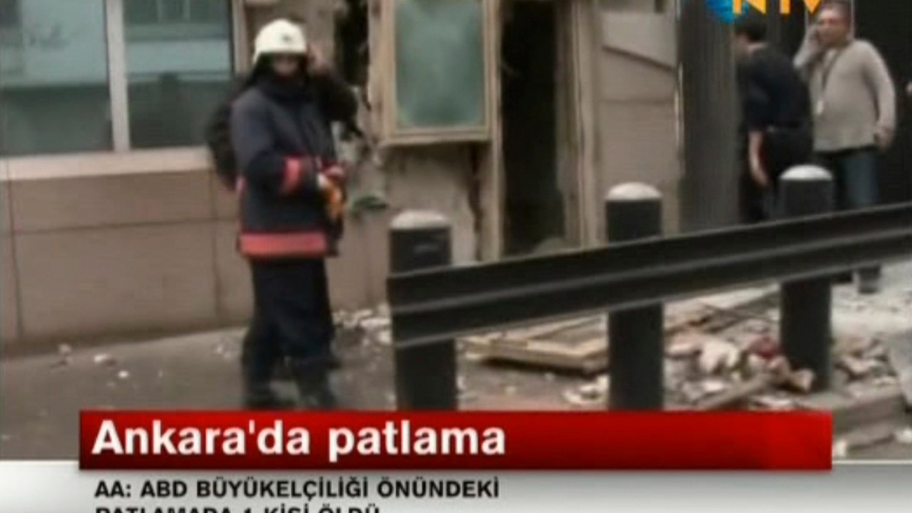 In this image made from video, emergency personnel are seen in front of a side entrance to the U.S. Embassy following a blast, Ankara, Turkey, Friday, Feb. 1, 2013. Turkish news reports say an explosion in front of the U.S. Embassy in the Turkish capital Ankara has injured several people. (AP Photo/NTV) TURKEY OUT