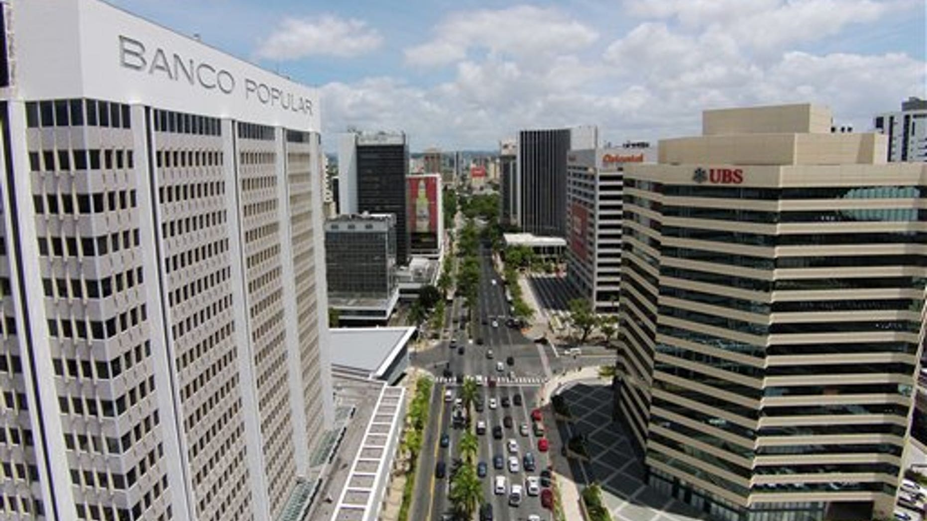 This July 16, 2014 photo shows the financial district in San Juan, Puerto Rico. Puerto Rico has seen a flurry of credit rating downgrades since the announcement of a law that allows some public corporations to restructure their debt if needed. The law was approved as the U.S. territory enters its eighth year in recession. (AP Photo/Ricardo Arduengo)