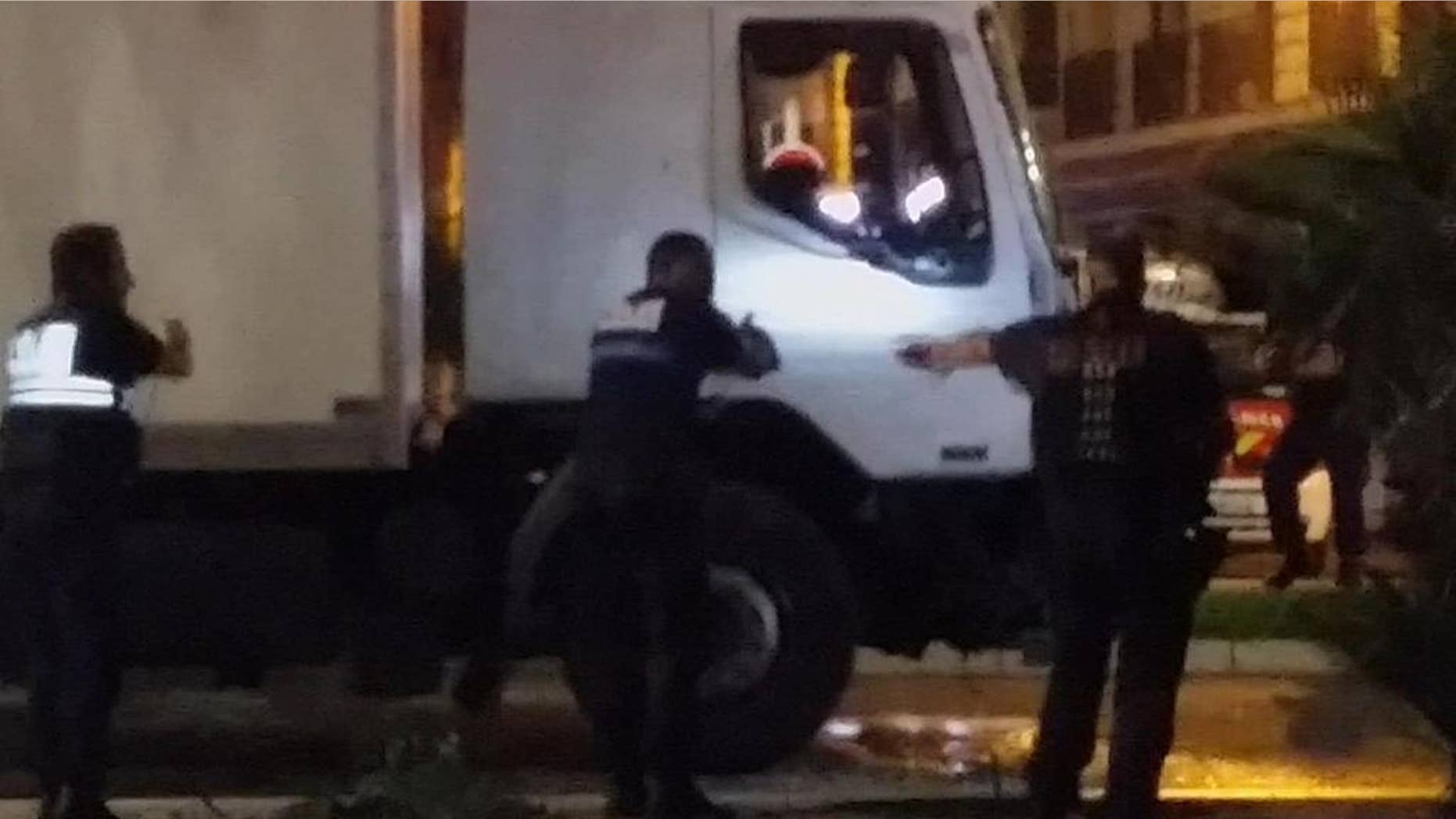 FILE - Police approach the cab of a truck driven by Mohamed Lahouaiyej Bouhlel, a Tunisian who plowed through a crowded promenade, killing at least 84 people in Nice, France, in this July 14, 2016, file photo. Bouhlel’s family and neighbors say he was indifferent to religion, but French authorities have linked the attack to Islamic State. (NADER EL SHAFEI via AP, File) MANDATORY CREDIT