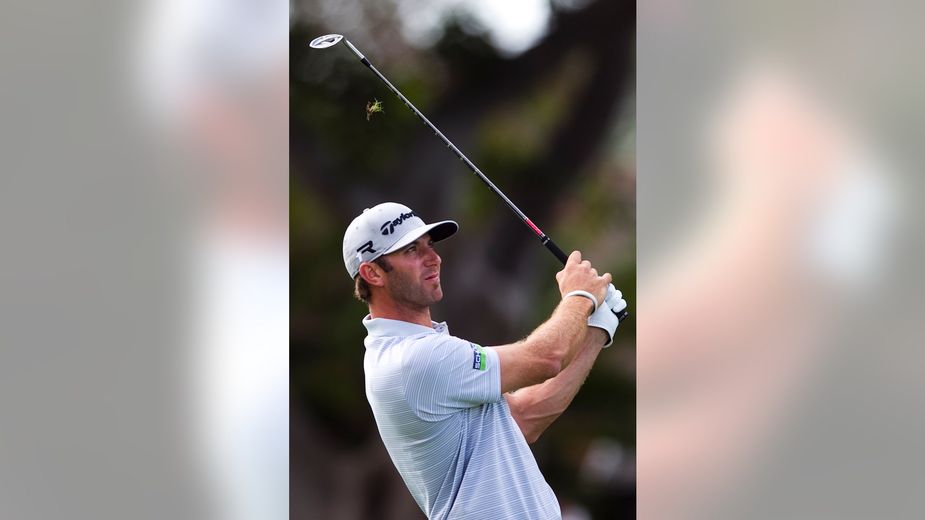 Dustin Johnson follows his shot off the first fairway during the first round of the Sony Open golf tournament on Thursday, Jan. 10, 2013, in Honolulu. (AP Photo/Marco Garcia)