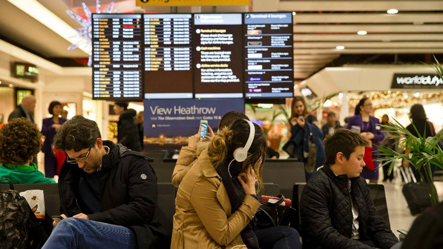 Passengers wait at Heathrow Airport in London, Friday, Dec. 12, 2014. London's airspace was closed today due to what authorities say was a computer failure at one of Britain's two air traffic control centres. Britain's national air traffic body says the computer problem that touched off troubles in the system has been fixed and it is in the process of returning to normal operations. (AP Photo/Vadim Ghirda)