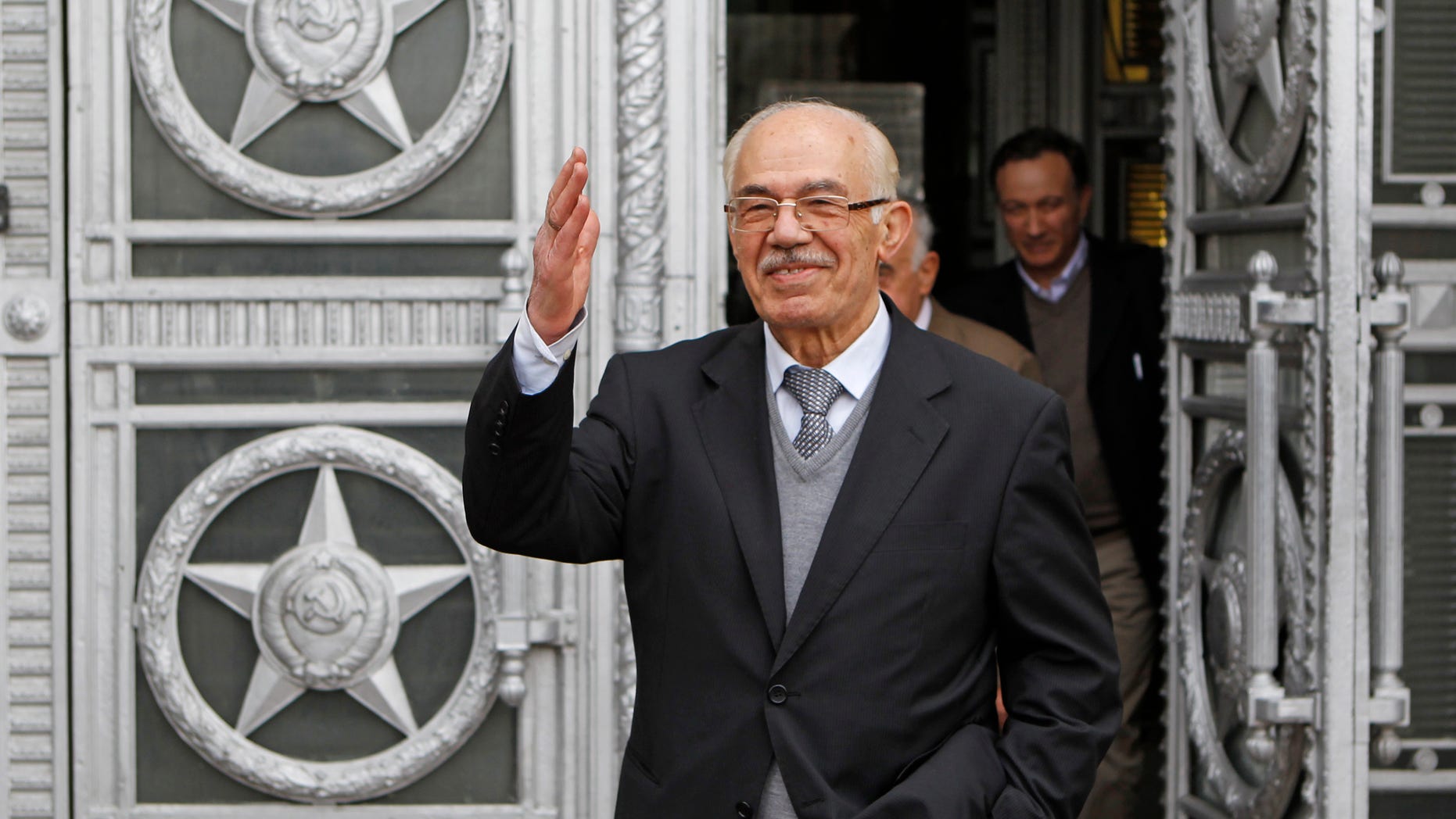 April 16: Syrian opposition member Hassan Abdul-Azim waves to press as he walks out of the Russian Foreign Ministry in Moscow after talks.